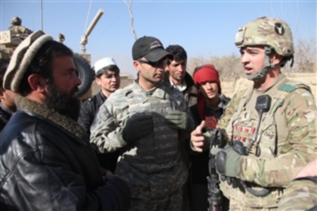 U.S. Army 1st Lt. Ben Davis (right), a combat engineer with the 832nd Engineer Company, attached to 1st Squadron, 113th Cavalry Regiment, speaks with Afghan men about security issues in Dolatshi village, Parwan province, Afghanistan, on Dec. 2, 2010.  The platoon visited the village to establish a traffic control point.  
