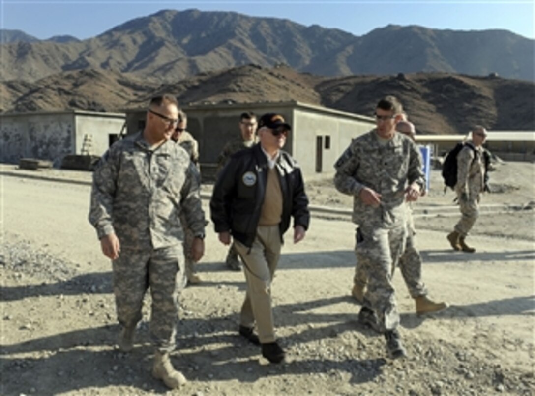 Secretary of Defense Robert M. Gates walks with Army Lt. Col. JB Vowell (right) after his arrival at Forward Operating Base Joyce, Afghanistan, on Dec. 7, 2010.  Gates is in Afghanistan receiving operational updates and thanking the troops for their service.  