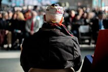 FARMINGDALE, N.Y. -- William Halleran, a Pearl Harbor survivor is recognized by the crowd inside the American Airpower Museum, during the Dropping of the Roses / Pearl Harbor Memorial Ceremony, here, Dec. 7. Halleran is 92 years old and has been making annual appearances at this ceremony for the last decade, this year he was one of four survivors to attend the ceremony. This is the 20th year of a tradition started by the late Joseph Stanley Hydrusko to honor those he served with at Pearl Harbor, Hawaii. Each year roses are dropped over the Statue of Liberty marking the time of the attack. In the attack, 21 ships were sunk or damaged, 188 aircraft were destroyed, and 2,335 service members were killed. America answered with an island-hopping campaign culminating with the iconic Marine Corps flag raising on Iwo Jima more than three years later. (Official Marine Corps photo by Sgt. Randall A. Clinton / RELEASED)