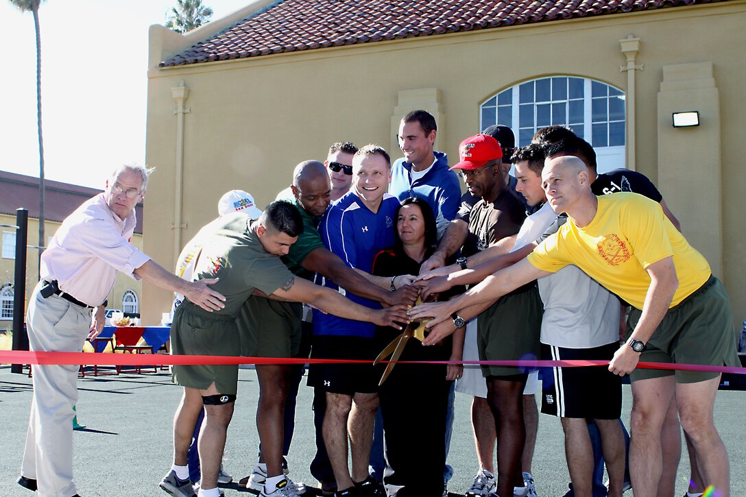 The Functional Fitness Center officially opened here Dec. 7. Attending the ceremony were Sgt. Maj. Sylvester D. Daniels, second from left, sergeant major of Marine Corps Recruit Depot San Diego; Fitness Guru Todd Durkin, third from left, Fitness Quest 10; Giovanna Thiesen, fitness center manager; and Maj. Gen. Ronald L. Bailey, sixth from left, commanding general, MCRD and the Western Recruiting Region. With the cutting of the ribbon the fitness center expansion now offers more opportunities for service members and their families to find the workout that is best for them.
