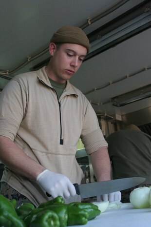 Sgt. Richard J. Martin, Marine Wing Support Squadron 171 food service specialist and chief cook, slices and dices green peppers and onions in the field expedient kitchen set up at Penny lake here Dec. 8 in preparation for the W.P.T. Hill Memorial Award competition.