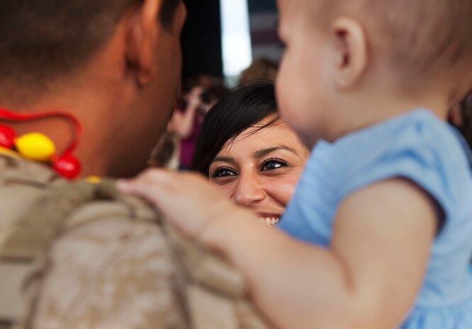 Seaman David Trevino, a corpsman with 3rd Battalion, 3rd Marine Regiment, shares a moment with his wife and 1-year-old daughter following his return to Marine Corps Base Hawaii from a seven-month deployment to Afghanistan, Dec. 7, 2010. After replacing 1st Battalion, 3rd Marine Regiment, in Helmand province’s Nawa district last May, 3/3 supported Regimental Combat Teams 1 and 7, as part of counterinsurgency operations during Operation Enduring Freedom. The battalion’s operations varied from securing elections and ensuring school openings, to more traditional combat operations such as security patrols and clearing danger areas, said Maj. Jay Garcia, executive officer, 3/3, of Honolulu. The return of “America’s Battalion” brought 925 Marines back to Hawaii.