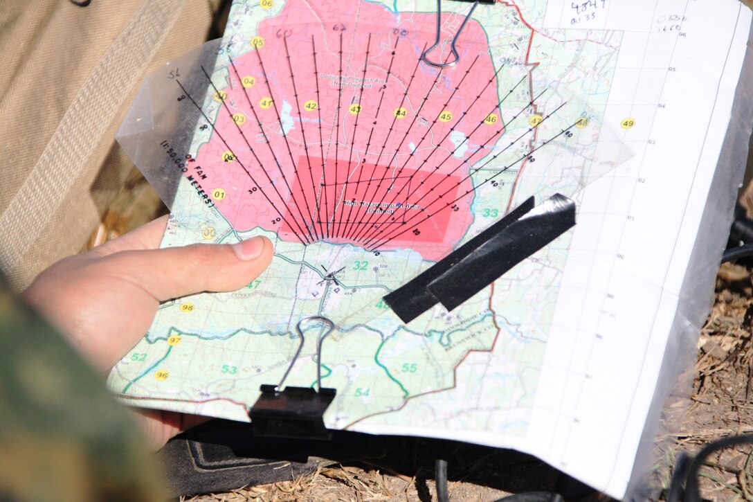 A radio operator from Easy Company, Battalion Landing Team, 2nd Battalion, 2nd Marine Regiment, 22nd Marine Expeditionary Unit, reads a map to direct mortar fire at a training site aboard Fort Pickett, Va., Dec. 7, 2010.  Easy Co. conducted a mechanized assault, which employed multiple assets to include armored assault vehicles, artillery and mortars. The BLT is conducting pre-deployment training exercises for the next two weeks in preparation for an upcoming deployment in 2011.  The 22nd MEU is a multi-mission capable force of 2,200 Marines and sailors and comprised of Aviation Combat Element, Marine Tilt Rotor Squadron 263 (Reinforced); Logistics Combat Element, Combat Logistics Battalion 22; Ground Combat Element, Battalion Landing Team, 2nd Battalion, 2nd Marine Regiment; and its command element.