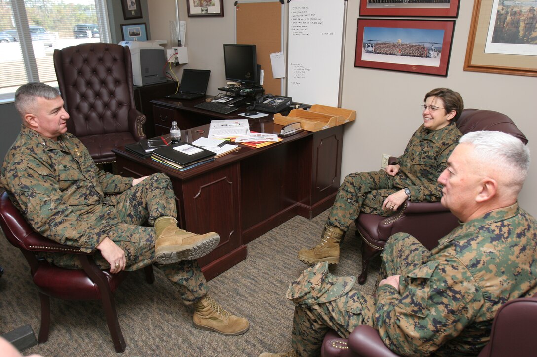 Rear Adm. Margaret G. Kibben, the chaplain of the Marine Corps; Brig. Gen. Glenn M. Walters, left; and Navy Capt. Rondall Brown, right, discuss the role of the Navy Chaplain Corps in the upcoming deployment of 2nd Marine Aircraft Wing (Forward) at the 2nd MAW (Fwd.) headquarters Dec. 8. Walters is the commanding general of 2nd MAW (Fwd.), and Brown is the chaplain for 2nd MAW (Fwd.).