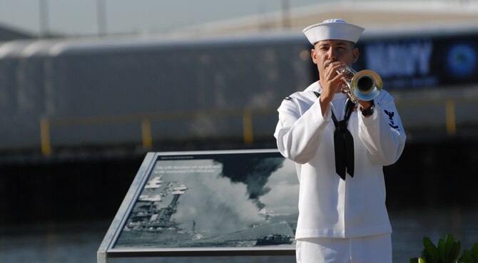 A Navy bugler plays taps during a commemoration ceremony at the Pearl Harbor Visitors Center at the World War II Valor in the Pacific National Monument Dec. 7, 2010. (U.S. Air Force photo by Staff Sgt. Carolyn Viss)