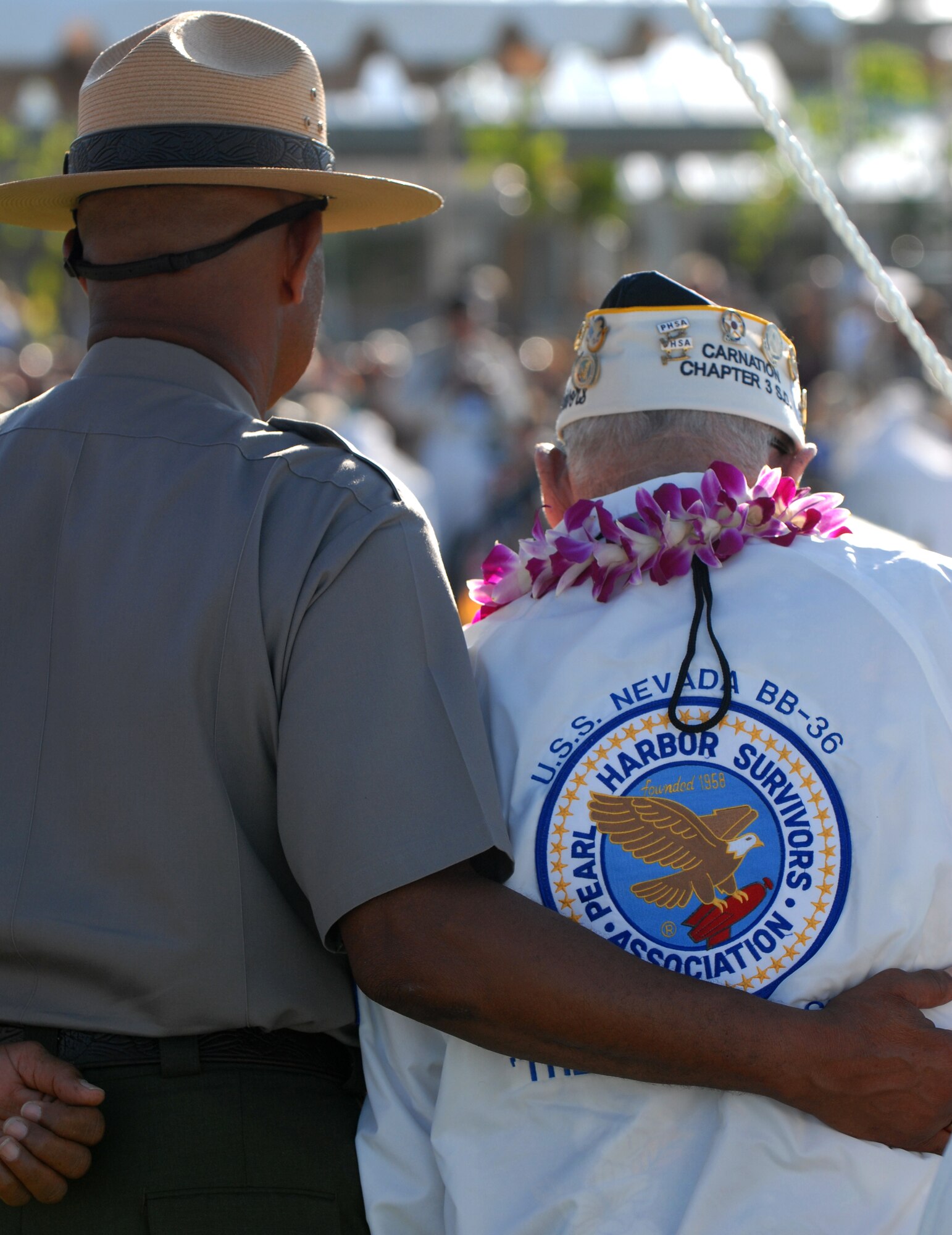 A member of the National Park Service helps one of the survivors of the Japanese attacks on Pearl Harbor Dec. 7, 1941, to stand during a commemoration ceremony at the Pearl Harbor Visitors Center at the World War II Valor in the Pacific National Monument Dec. 7, 2010. (U.S. Air Force photo by Staff Sgt. Carolyn Viss)