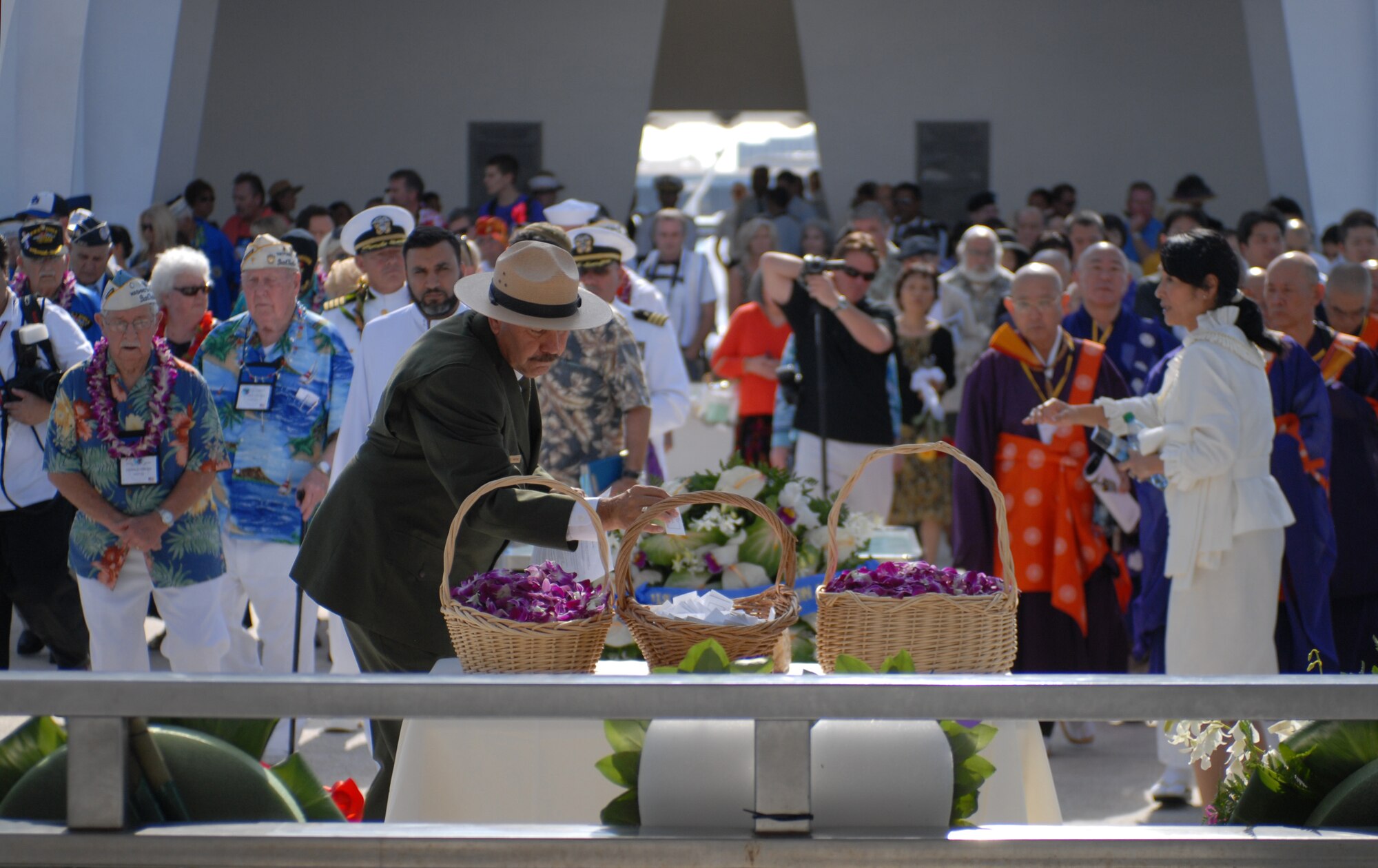Daniel A. Martinez, National Park Service Chief Historian for the World War II Valor in the Pacific National Monument, picks a card holding one of the names of one of the 2,403 American lives that were lost during the Japanese attacks on Pearl Harbor Dec. 7, 1941, during a ceremony on board the USS Arizona Memorial Dec. 7, 2010. (U.S. Air Force photo by Staff Sgt. Carolyn Viss)