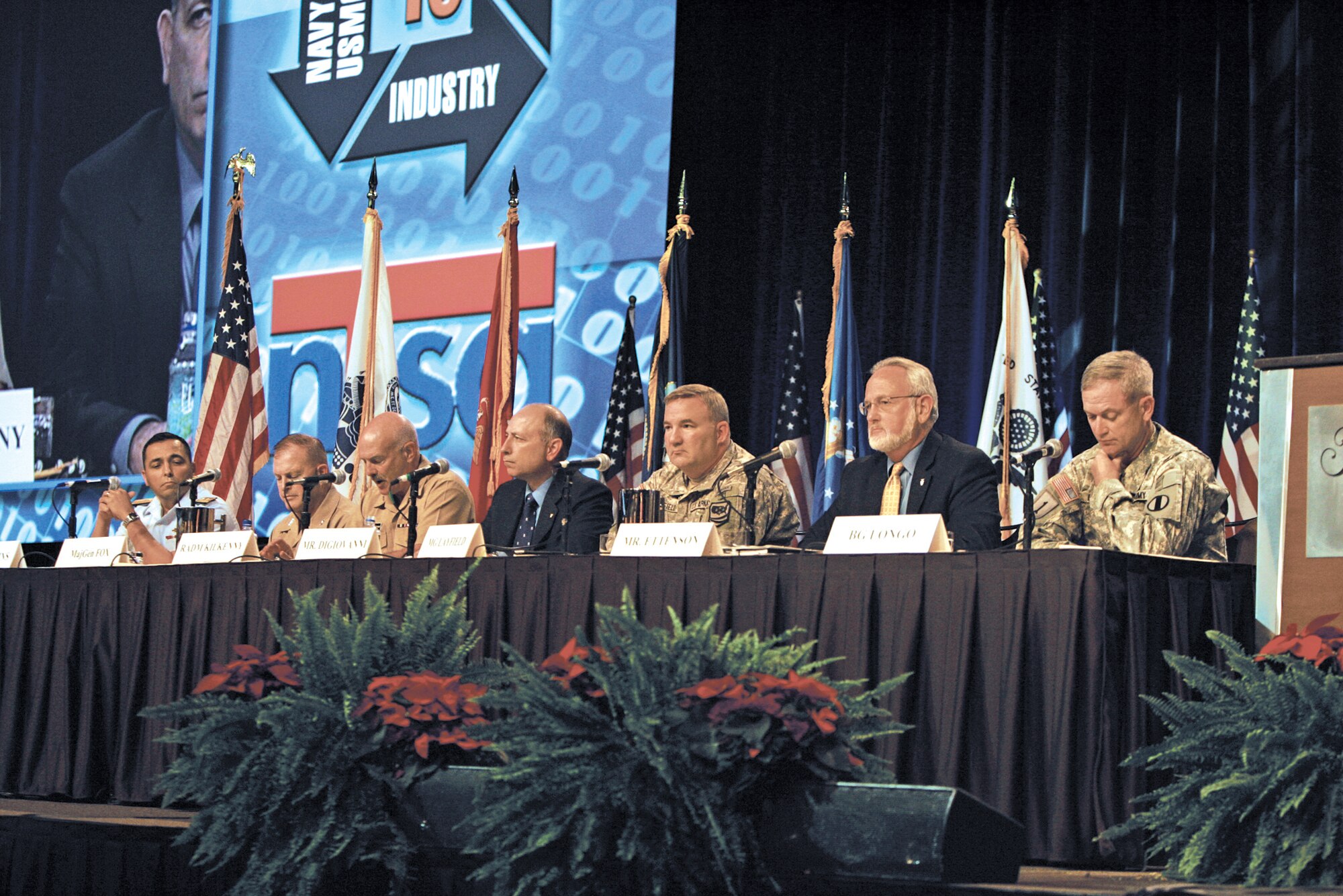 Defense Department panel members present their views Nov. 30, 2010, during the Interservice/Industry Training Simulation and Education Conference in Orlando, Fla. Each senior leader presented his perspective on the need to anticipate service modeling and simulation requirements to be ready for the full spectrum of potential threats future joint warfighters may face. On the panel are (from left) Coast Guard Rear Adm. Vincent Atkins, Marine Maj. Gen. Raymond Fox, Navy Rear Adm. Joseph Kilkenny, Frank DiGiovanni (DOD), Army Maj. Gen. Stephen Layfield, Gordon Ettenson (Air Force), and Army Brig. Gen. Richard Longo.  (Courtesy photo)