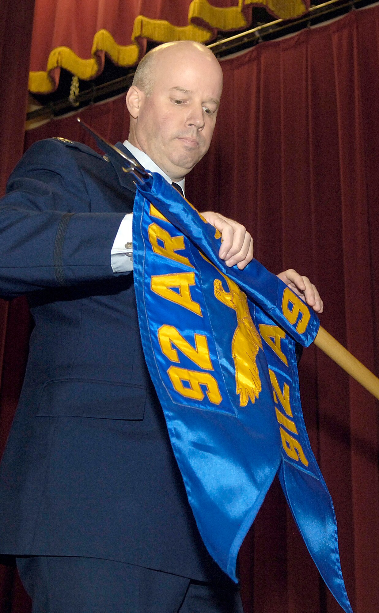 Col. Paul H. Guemmer unveils the 912th Air Refueling Squadron guidon during a reactivation ceremony for the squadron Dec. 3, 2010, at March Air Reserve Base, Calif.  As a facet of Total Force Integration, operationally the squadron will be part of the Air Force Reserve Command’s 452nd Air Mobility Wing while its parent unit, the 92nd Air Refueling Wing at Fairchild Air Force Base, Wash., will retain administrative control of the squadron. Colonel Guemmer is the 92nd ARW commander. (U.S. Air Force photo/ Senior Airman Natasha E. Stannard)