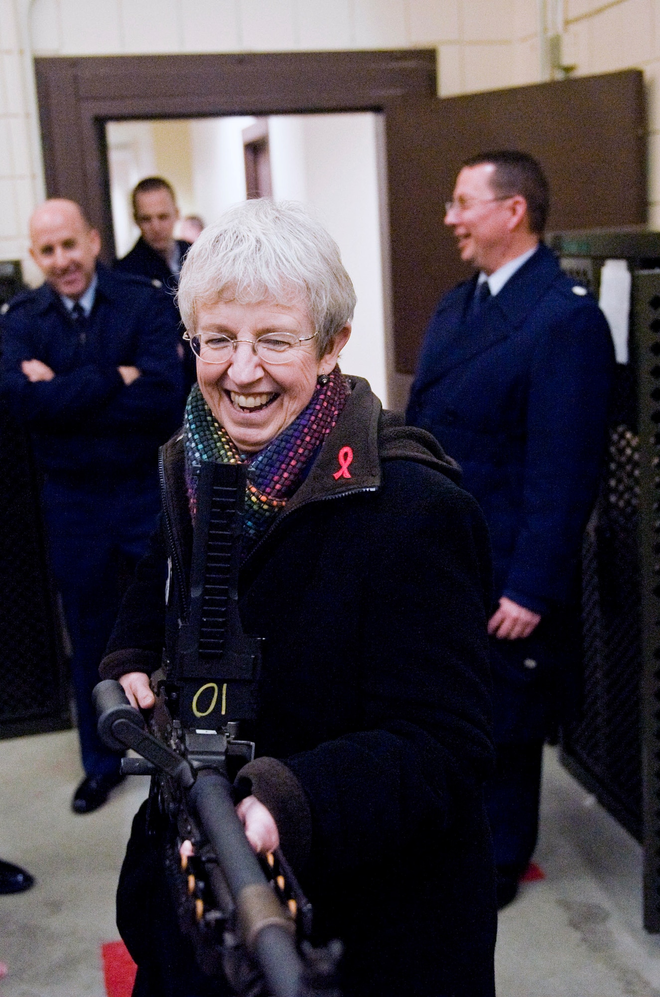 Anchorage School District Superintendent Carol Comeau hefts a M240B 7.62-millimeter machine gun, Monday, at the Joint Base Elmendorf-Richardson Combined Arms Training Facility. Comeau visited the facility as part of an ASD executive exchange with her counterpart, 673d Mission Support Group Commander Air Force Col. Ed Thomas. (U.S. Air Force photo/A1C Christopher Gross)