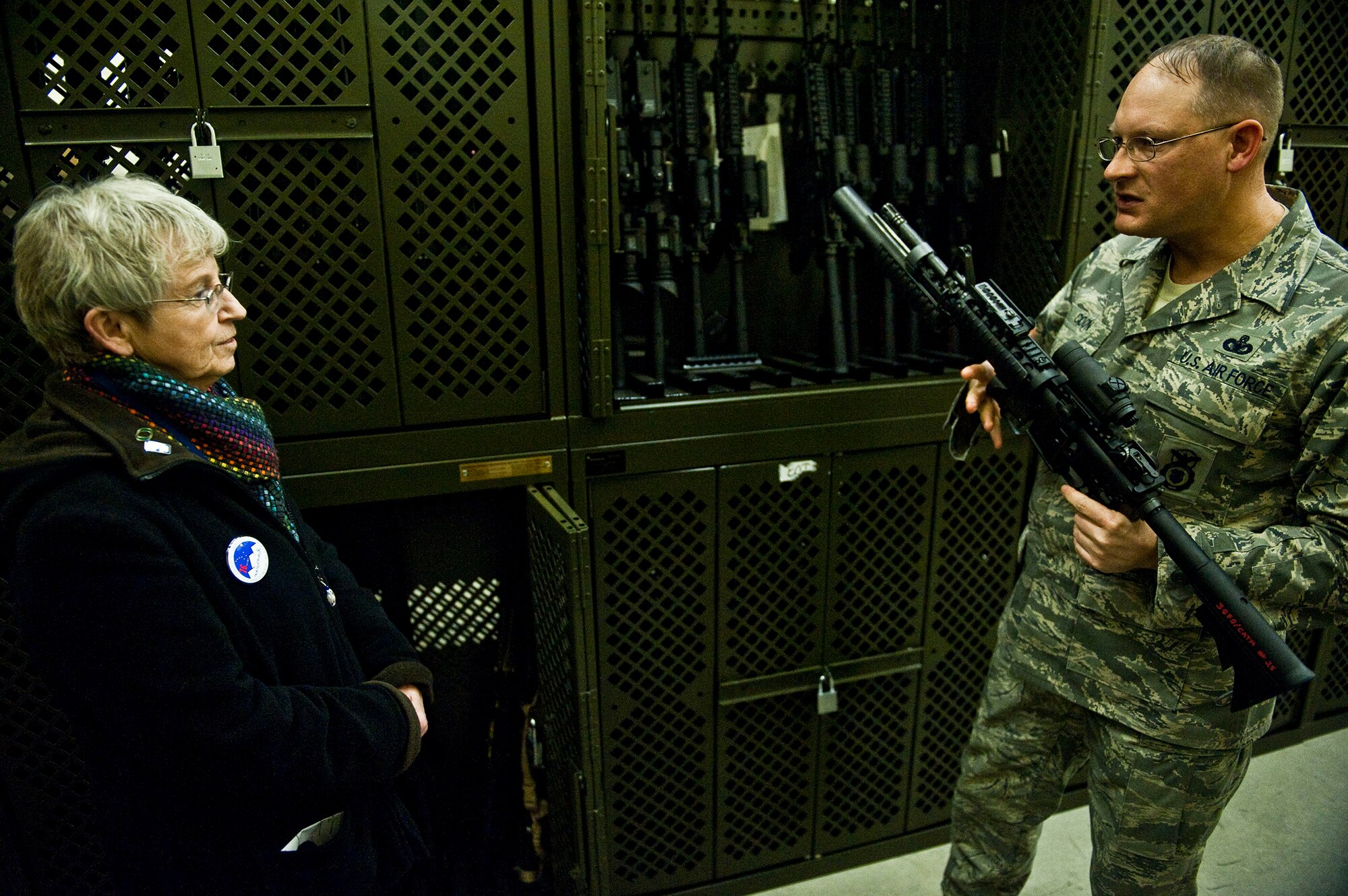 Air Force Master Sgt. Daniel Coon, 673d Security Forces Squadron combat arms instructor shows the finer points of the M4 carbine, complete with M203 grenade launcher and reflex sight, to Anchorage School District Superintendent Carol Comeau, Monday, during her executive exchange with 673d Mission Support Group. (U.S. Air Force photo/A1C Christopher Gross)