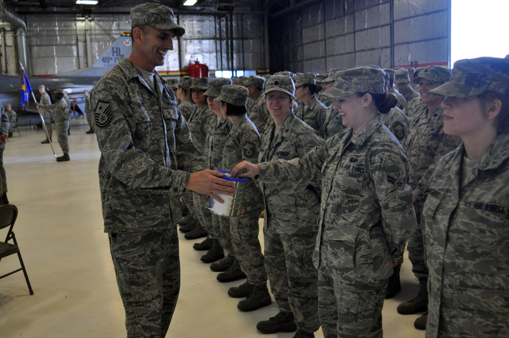 Master Sgt. Christopher Sayre, 419th Security Forces Squadron first sergeant, collects donations for Operation Diamond Heart before the 419th Fighter Wing's change of command ceremony Dec. 5. The funds will help Airmen and families in need this holiday season. (U.S. Air Force photo/Staff Sgt. Alan Schultz)