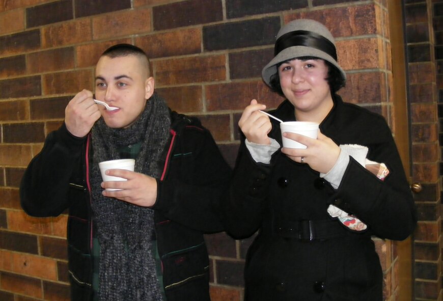 GARRISON, N.D. -- Airmen Jacob Balanzategui and Margherita Romano, both 5th Maintenance Operations Squadron maintenance management analysts from Minot Air Force Base, N.D., visited the Dickens Village Festival here Dec. 4 to indulge in the many activities of the area. As part of their visit, the two purchased soup from local vendors. (BHG News Service photo/Cheryl Odden)