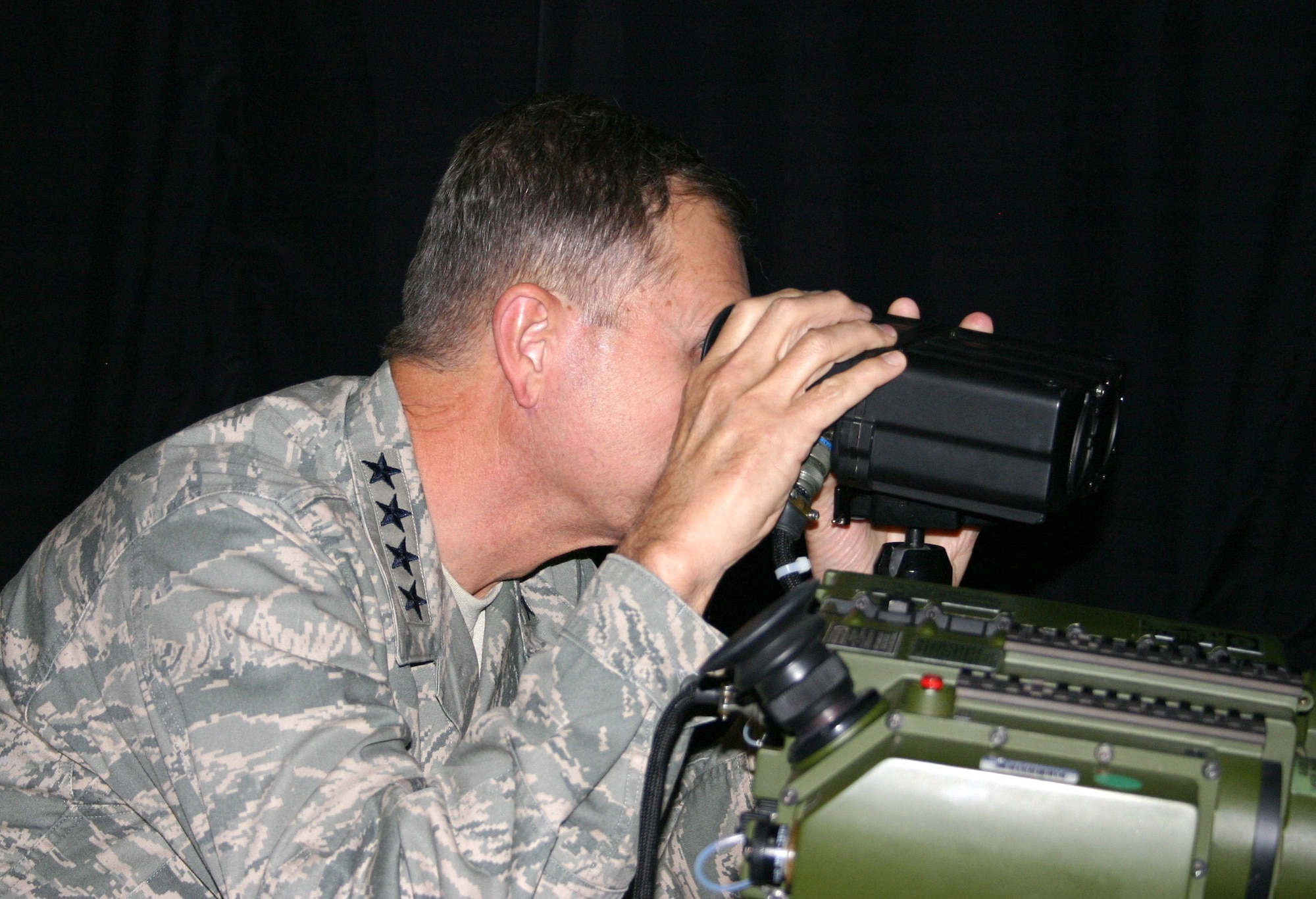 Gen. William M. Fraser III, Air Combat Command commander, uses the Mk-7 Laser Range Finder during a tour of the 705th Combat Training Squadron’s Distributed Mission Operations Center on Pearl Harbor Day, just prior to the start of the classified Pacific-scenario exercise Virtual Flag 11-1. The range finder is part of the Joint Close Air Support Operation Simulator used to train tactical air control party members. VF exercises are conducted four times a year, with one dedicated to coalition warfare.  The virtual exercises are part of the 505th Command and Control Wing’s, Hurlburt Field, Fla., mission to improve warfighter capability through command and control testing, tactics development and training. (U.S. Air Force photo/Tech. Sgt. Sidney Wells)