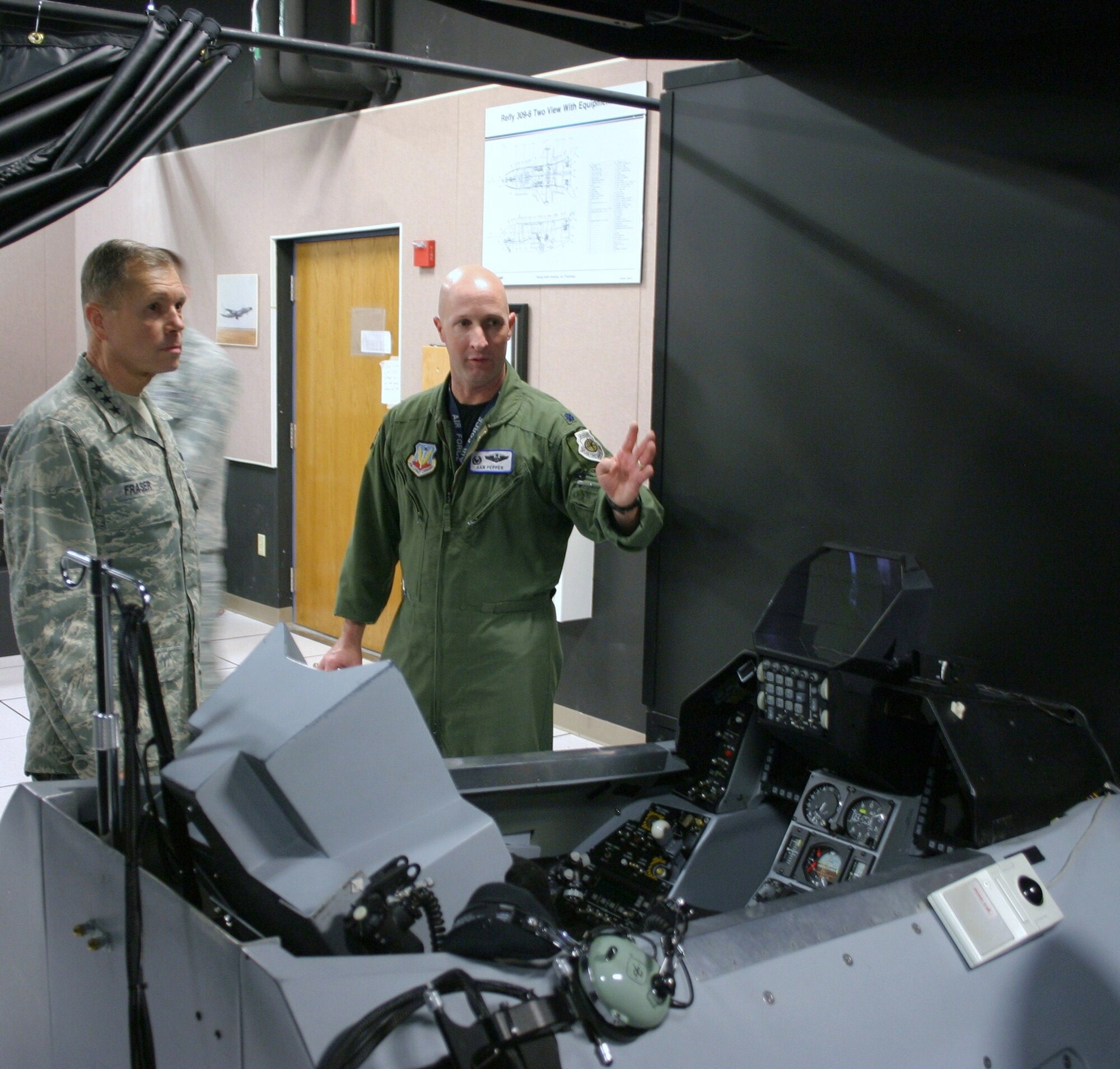 Lt. Col. Daniel Pepper, 705th Combat Training Squadron commander, explains to Gen. William M. Fraser III, Air Combat Command commander, virtual training, the linking of simulators, modeling and simulation programs and computer generated forces, the squadron’s Distributed Mission Operations Center can provide. General Fraser toured the DMOC on Pearl Harbor Day, just prior to the start of the classified Pacific-scenario exercise Virtual Flag 11-1. VF exercises are conducted four times a year, with one dedicated to coalition warfare.  The virtual exercises are part of the 505th Command and Control Wing’s, Hurlburt Field, Fla., mission to improve warfighter capability through command and control testing, tactics development and training. (U.S. Air Force photo/Tech. Sgt. Sidney Wells)