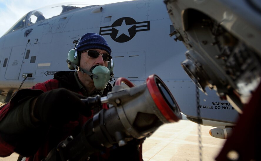 Tech. Sgt. Dewayne Magnuson, 442nd Fighter Wing, Air Reserve technician, attaches a fuel hose to an A-10 Thunderbolt II during a hot pit refuel, Dec. 8. Hot pit refueling is a procedure usually performed in a combat situation to rapidly refuel aircraft while their engines are running resulting in a speedy refuel to thrust pilots right back into the fight. The 442nd Air Reserve technicians practice this procedure to keep their skills sharp. (U.S. Air Force photo by Senior Airman Kenny Holston)(Released)
