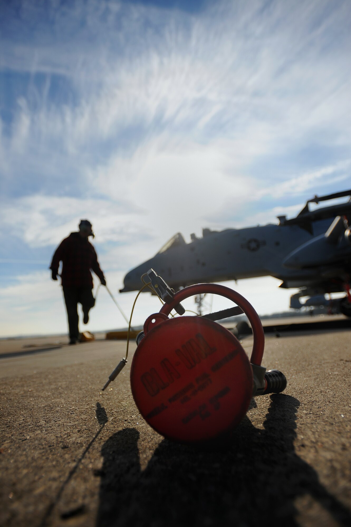 A jet fuel hose for refueling is discarded after a hasty hot pit refuel for a 442nd Fighter Wing A-10 Thunderbolt, Dec. 8. Hot pit refueling is a procedure usually performed in a combat situation to rapidly refuel aircraft while their engines are running resulting in a speedy refuel to thrust pilots right back into the fight. The 442nd Air Reserve technicians practice this procedure to keep their skills sharp. (U.S. Air Force photo by Senior Airman Kenny Holston)(Released)
