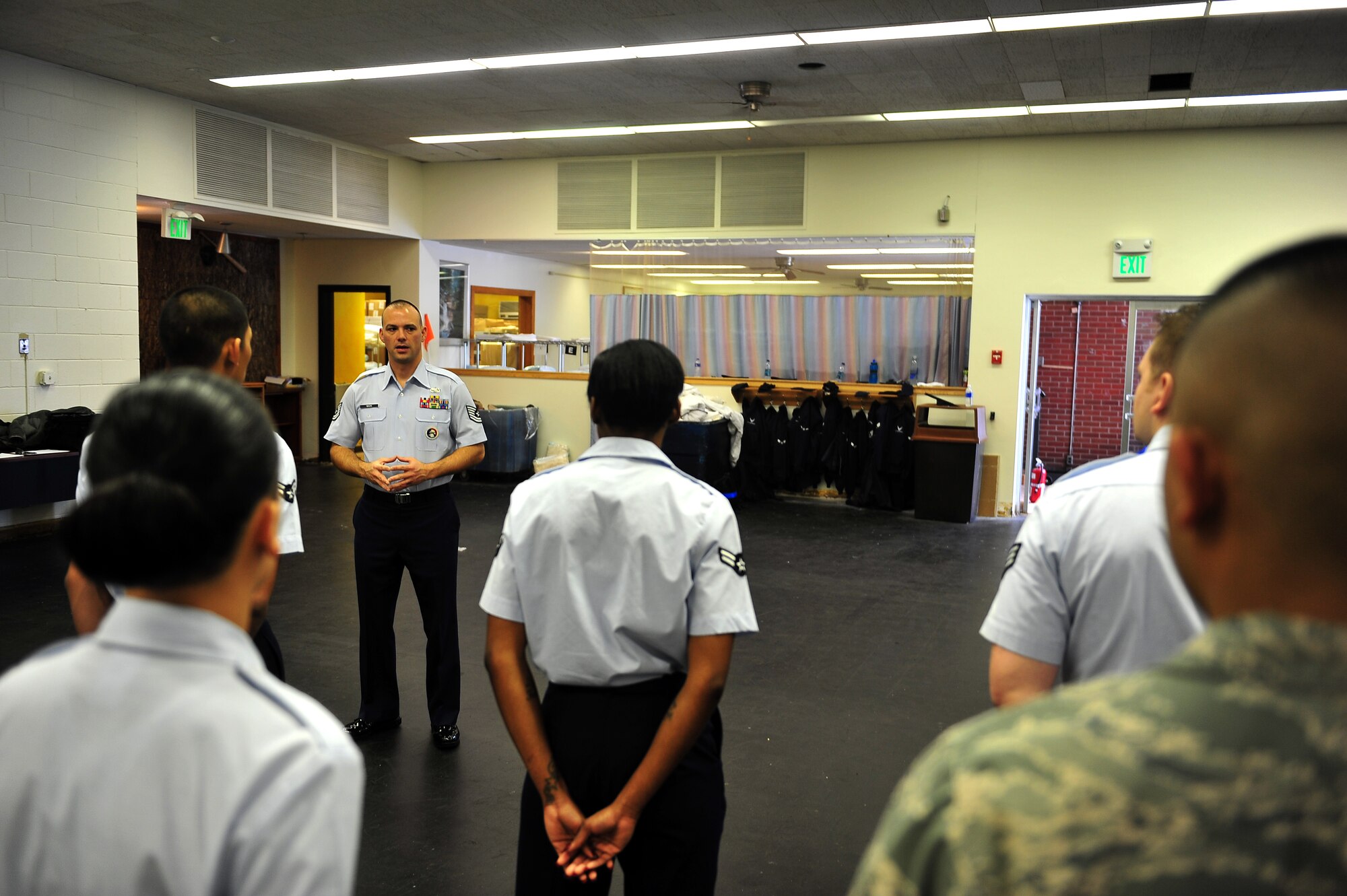 MINOT AIR FORCE BASE, N.D. -- Tech. Sgt. Paul Nixon, Minot AFB Honor Guard noncommissioned officer in charge, instructs new recruits on standing manuals during a training course here Dec. 6. The training course provides the opportunity to prepare the new Airmen for base honor guard duties. (U.S. Air Force photo/Senior Airman Michael J. Veloz)