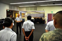 MINOT AIR FORCE BASE, N.D. -- Tech. Sgt. Paul Nixon, Minot AFB Honor Guard noncommissioned officer in charge, instructs new recruits on standing manuals during a training course here Dec. 6. The training course provides the opportunity to prepare the new Airmen for base honor guard duties. (U.S. Air Force photo/Senior Airman Michael J. Veloz)