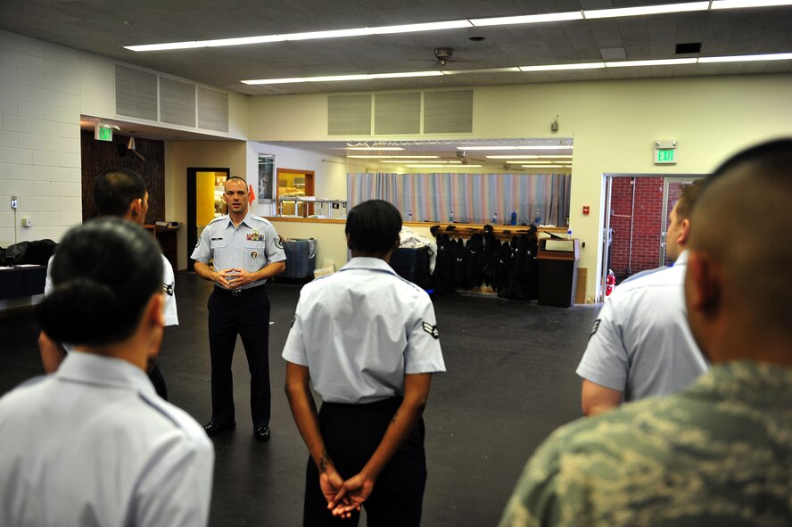 MINOT AIR FORCE BASE, N.D. -- Tech. Sgt. Paul Nixon, Minot AFB Honor Guard noncommissioned officer in charge, instructs new recruits on standing manuals during a training course here Dec. 6. The training course provides the opportunity to prepare the new Airmen for base honor guard duties. (U.S. Air Force photo/Senior Airman Michael J. Veloz)