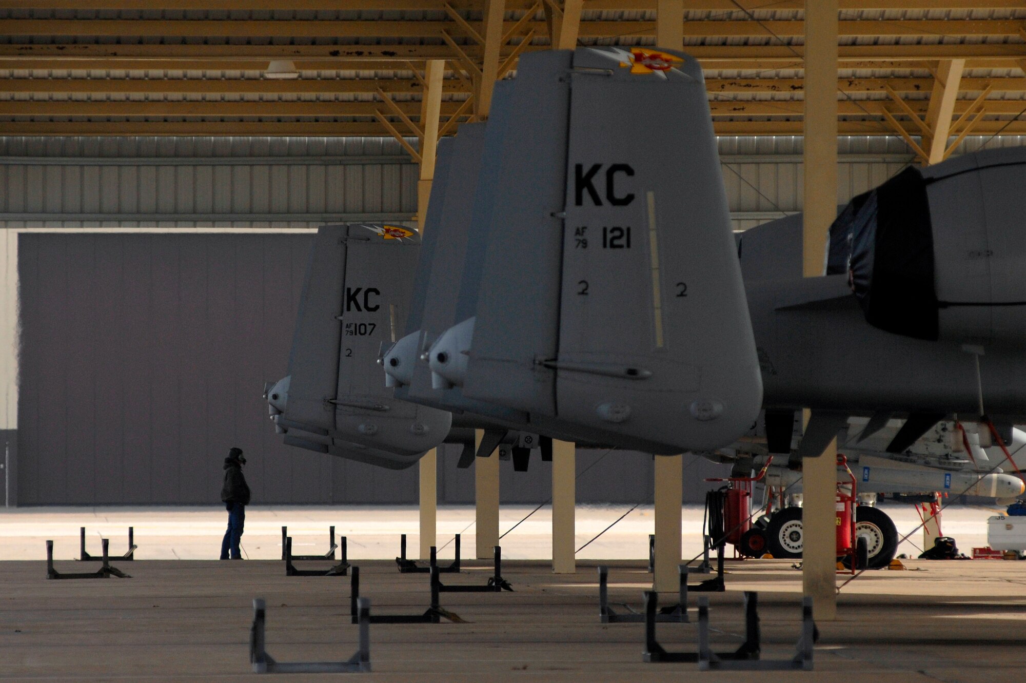A crew chief with the 442nd Fighter Wing at Whiteman helps prepare an A-10 Thunderbolt II for launch, Dec. 8. Pilots and crew chiefs worked together to execute sorties throughout the day and conducted hot pit refueling to keep their skills sharp and achieve additional sorties. Hot pit refueling is a procedure usually performed in combat situations to rapidly refuel aircraft while their engines are running, resulting in a speedy refuel to thrust pilots right back into the fight. (U.S. Air Force photo by Senior Airman Kenny Holston)(Released)

