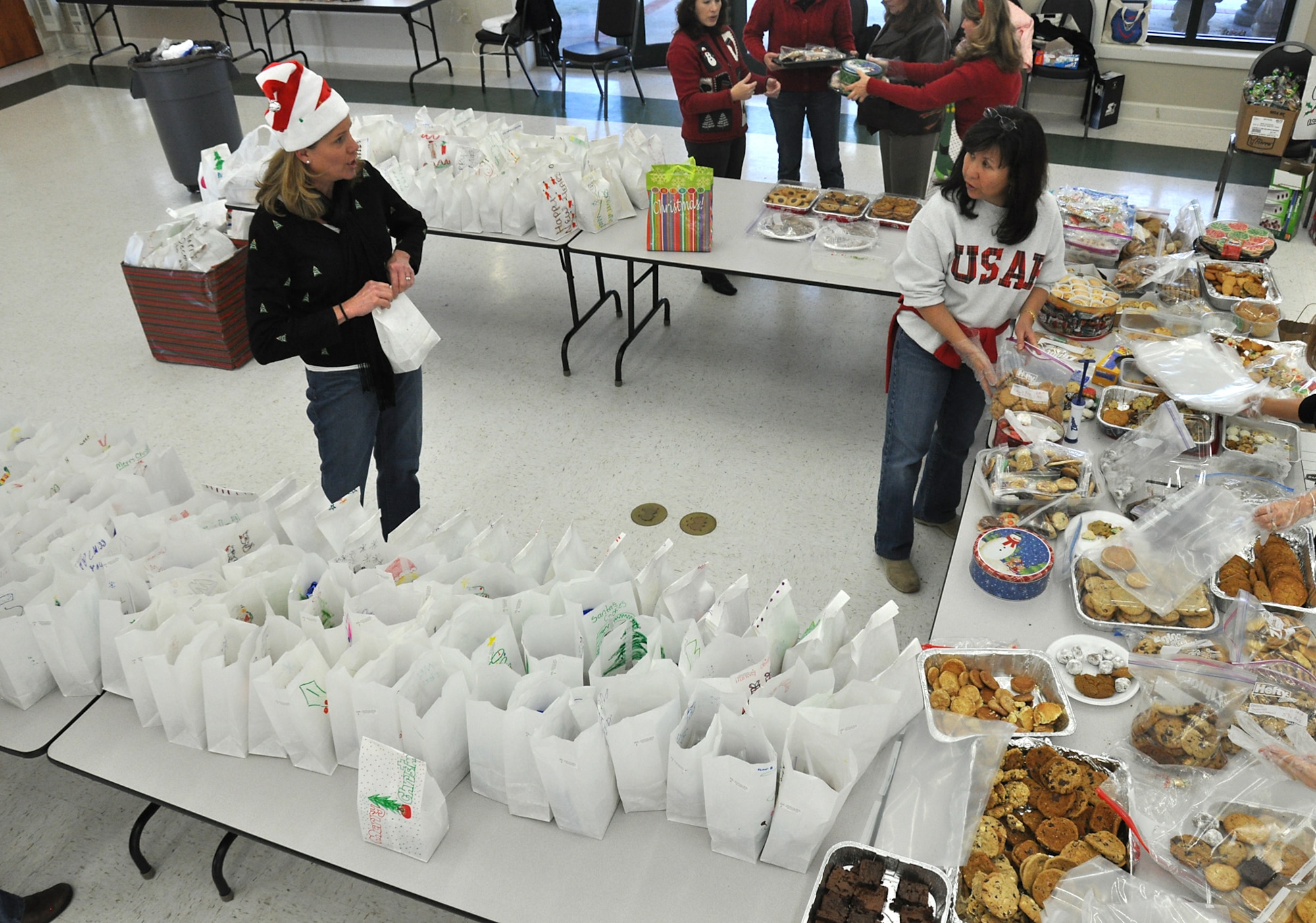 During it's 2nd Annual Cookie Drop, members of the Team Charleston Spouses Club prepapre about 500 bags of assorted holiday cookies in the base chapel annex Dec. 8. The cookies were shipped to deployed members of Team Charleston and given to dorm residents.