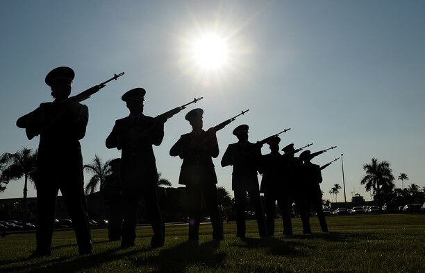 The Hickam Honor Guard fires a three round volley during the 69th anniversary ceremony of the surprise attacks on the Hawaiian Islands. Airmen, families and veterans gathered at Atterbury Circle, the site of same flag pole that stood Dec. 7, 1941, to commemorate the lives and the sacrifices of the men and women who were there on that day. (U.S. Air Force/Staff Sgt. Mike Meares)