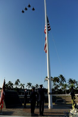 The Montana Air National Guard F-15 Eagles fly in the missing man formation to signal the start of the 69th anniversary ceremony of the surprise attacks on the Hawaiian Islands. Airmen, families and veterans gathered at Atterbury Circle, the site of same flag pole that stood Dec. 7, 1941, to commemorate the lives and the sacrifices of the men and women who were there on that day. (U.S. Air Force/Staff Sgt. Mike Meares)