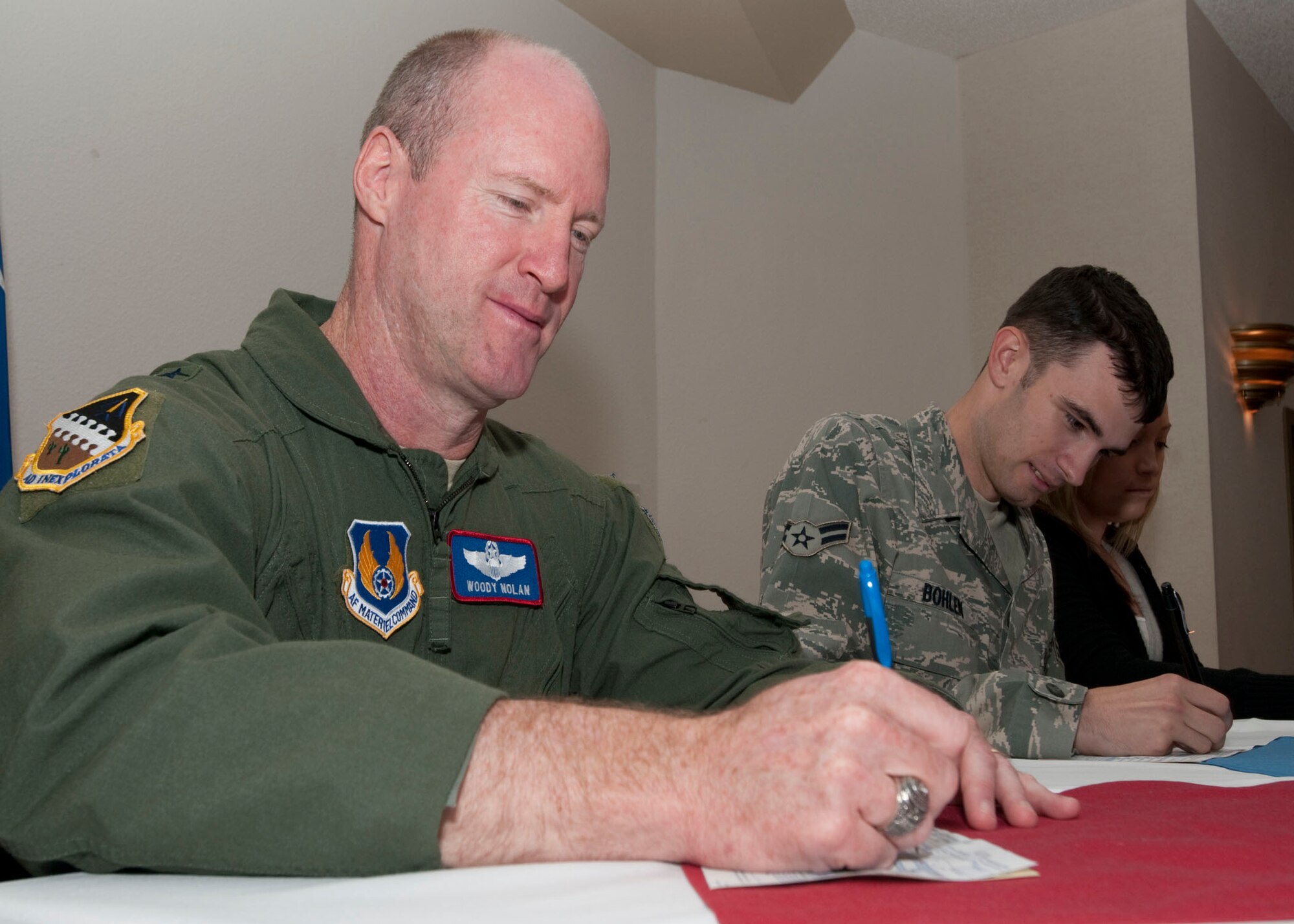 Brig. Gen. Robert C. Nolan II, Air Force Flight Test Center commander, fills out a 2010 Combined Federal Campaign donation form with Airman First Class Allan Bohlen, 95th Communications Squadron network management technician, during the Edwards CFC kickoff Oct. 6. Edwards wrapped up this year’s CFC meeting 108 percent of its goal. (Air Force photo by Doug Spinks)