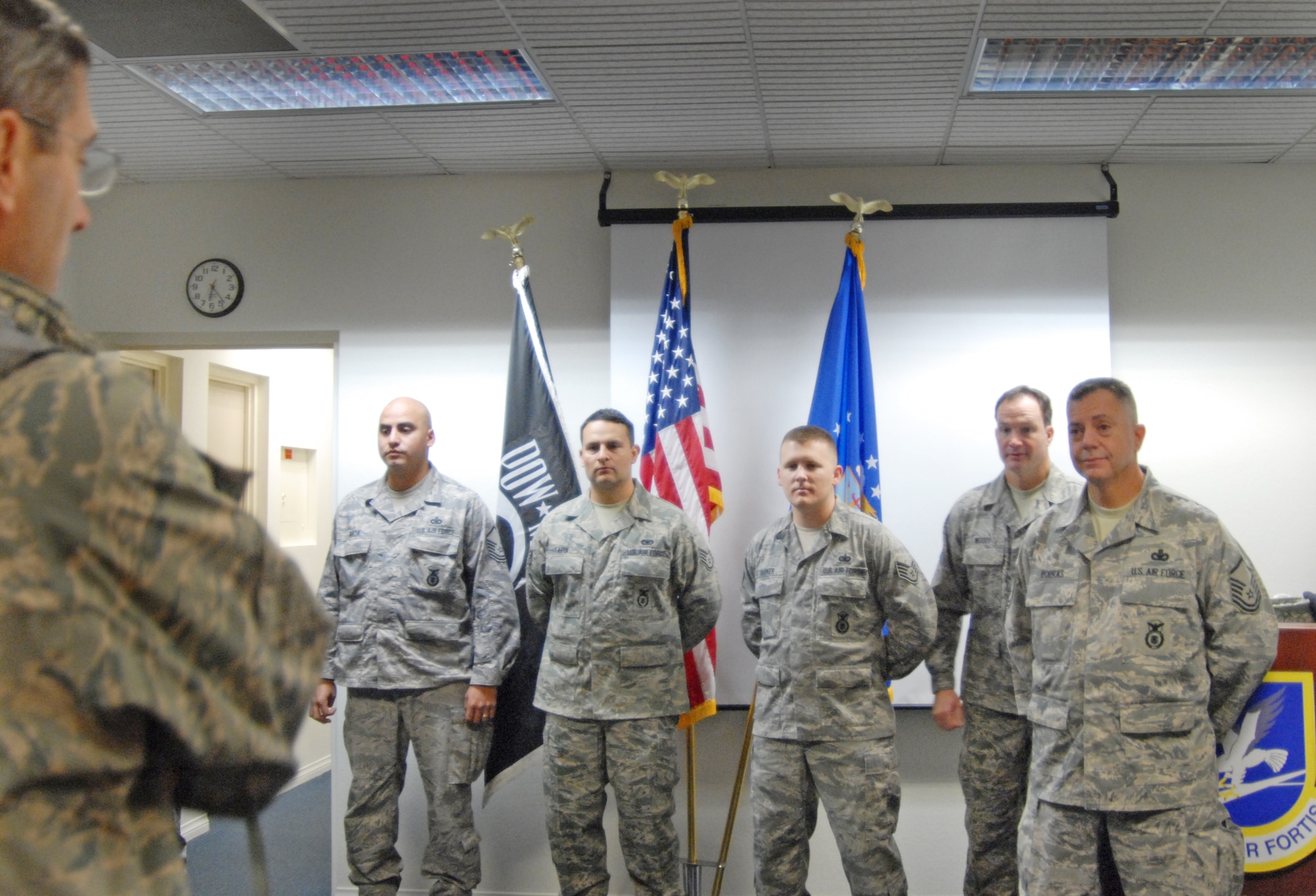 Col. Gregory E. Schwab, 95th Air Base Wing commander, addresses members of the 95th ABW Security Forces Individual Mobilization Augmentee team with well wishes and gratitude. The 95th SFS IMA team deployed from Edwards, Dec. 3, for Iraq where they will serve until summer 2011. (Air Force photo by Kate Blais)