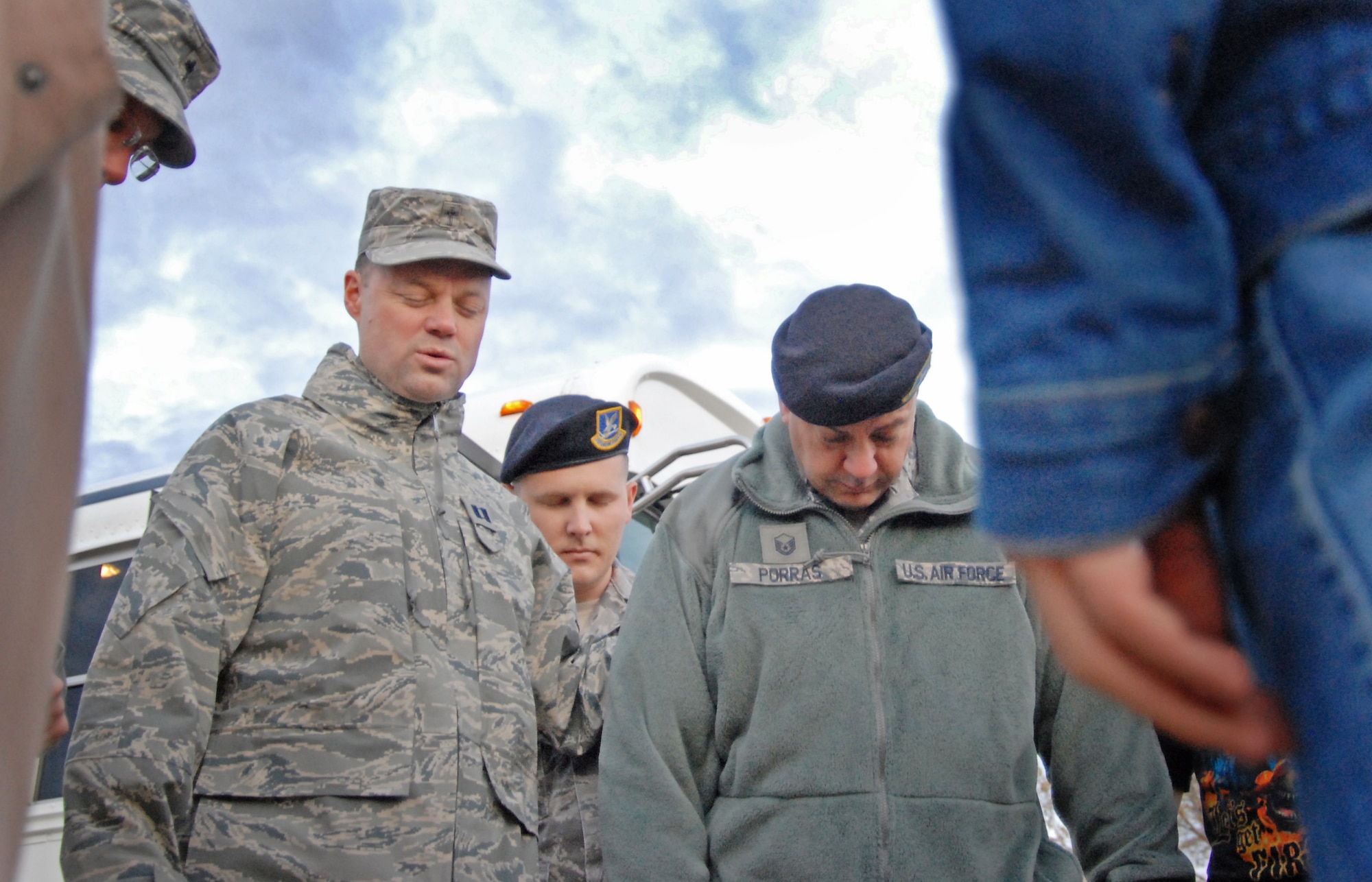 Bowing their heads in reflection, Capt. Brian Clouse, 95th Air Base Wing chaplain, leads a prayer for the 95th ABW Security Forces Individual Mobilization Augmentee team. The team deployed from Edwards, Dec. 3, and will serve in Iraq until summer 2011. (Air Force photo by Kate Blais)