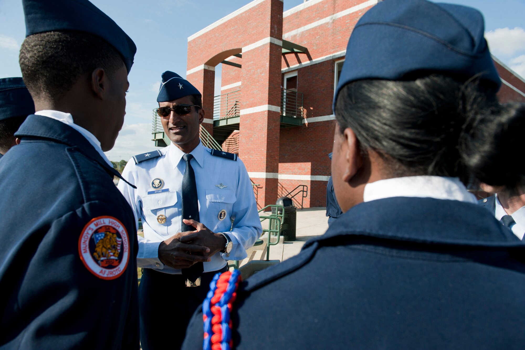 Brig. Gen. Balan R. Ayyar, the Air Force Recruiting Service commander, speaks with several Mundy's Mill High School Junior ROTC cadets Dec. 4, 2010, during the 2010 Pioneer Bowl at the A.J. McClung Memorial Stadium in Columbus, Ga. The cadets traveled from Jonesboro, Ga., to present the flags during the national anthem. It was their first time participating in the Pioneer Bowl. (U.S. Air Force photo/Senior Airman Jamal D. Sutter)