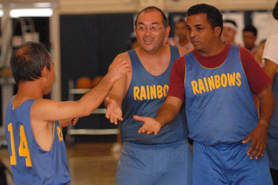 Special Olympics Rainbows basketball team members share a moment of camaraderie during a game at Joint Base Pearl Harbor-Hickam, Hawaii, Dec. 4, 2010. (U.S. Air Force photo/Staff Sgt. Carolyn Viss)