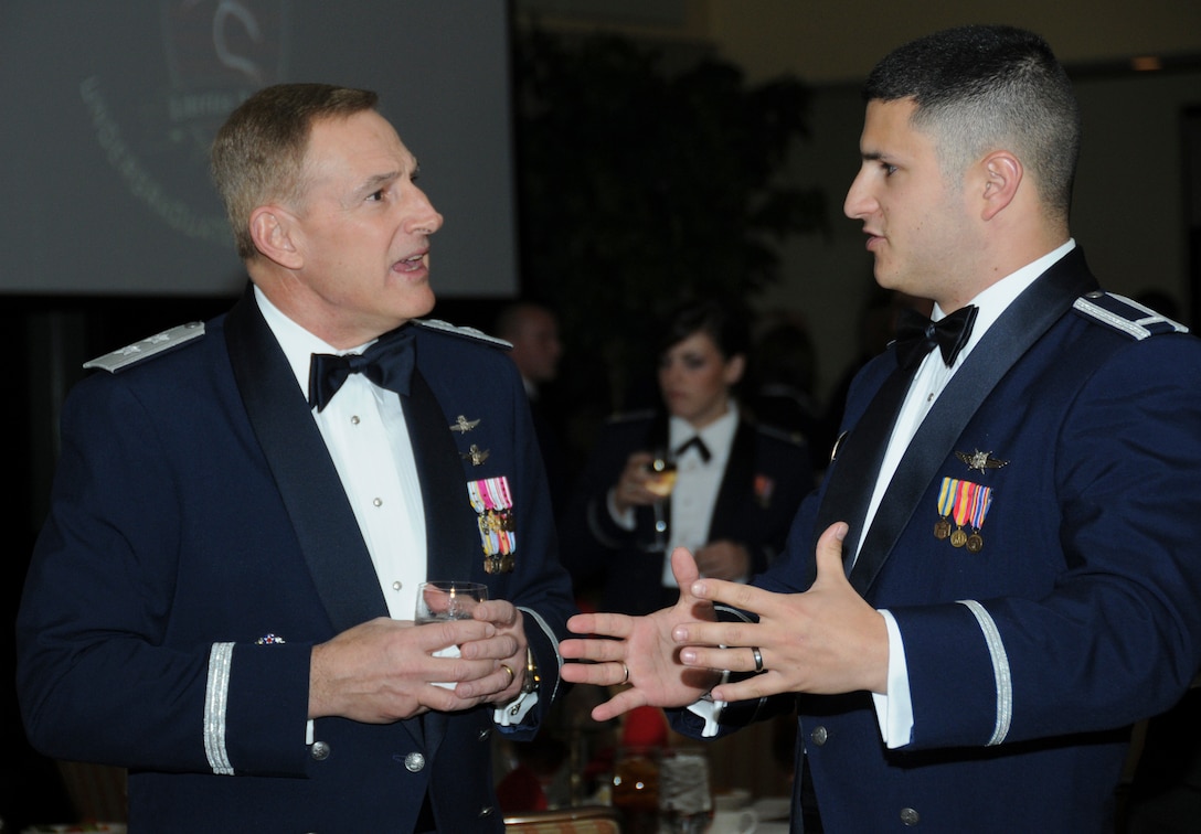 Maj. Gen. Michael Basla, left, speaks with 1st Lt. Christian Ford Dec. 6, 2010, at a dinner honoring the Air Force's first undergraduate cyberspace training graduates at Keesler Air Force Base, Miss. General Basla is the vice commander of Air Force Space Command at Peterson Air Force Base, Colo. Lieutenant Ford is an instructor in the 333rd Training Squadron at Keesler AFB, where the course is taught. (U.S. Air Force photo/Kemberly Groue)