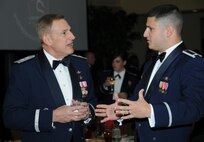 Maj. Gen. Michael Basla, left, speaks with 1st Lt. Christian Ford Dec. 6, 2010, at a dinner honoring the Air Force's first undergraduate cyberspace training graduates at Keesler Air Force Base, Miss. General Basla is the vice commander of Air Force Space Command at Peterson Air Force Base, Colo. Lieutenant Ford is an instructor in the 333rd Training Squadron at Keesler AFB, where the course is taught. (U.S. Air Force photo/Kemberly Groue)