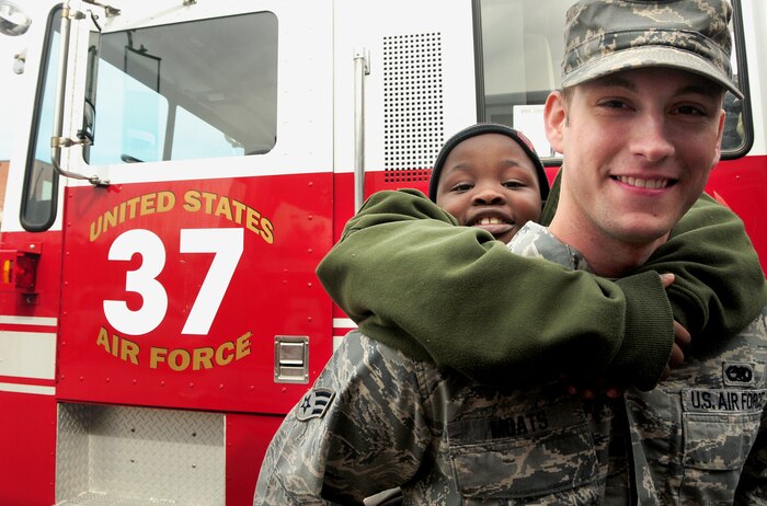 William Goodwin rides piggy-back with his "buddy" Senior Airman Corey Moats at the base fire department during a school tour Dec. 2, 2010, on Joint Base Charleston-Air Base, S.C. William and fellow classmates from Memminger Elementary School paired-up with students enrolled at the base's Airman Leadership School during the tour of the base. For the children, the event provided a chance to learn about military life and history. For the Airmen, it was an opportunity to mentor and give back to the local community. (U.S. Air Force photo/Staff Sgt. Daniel Bowles)
