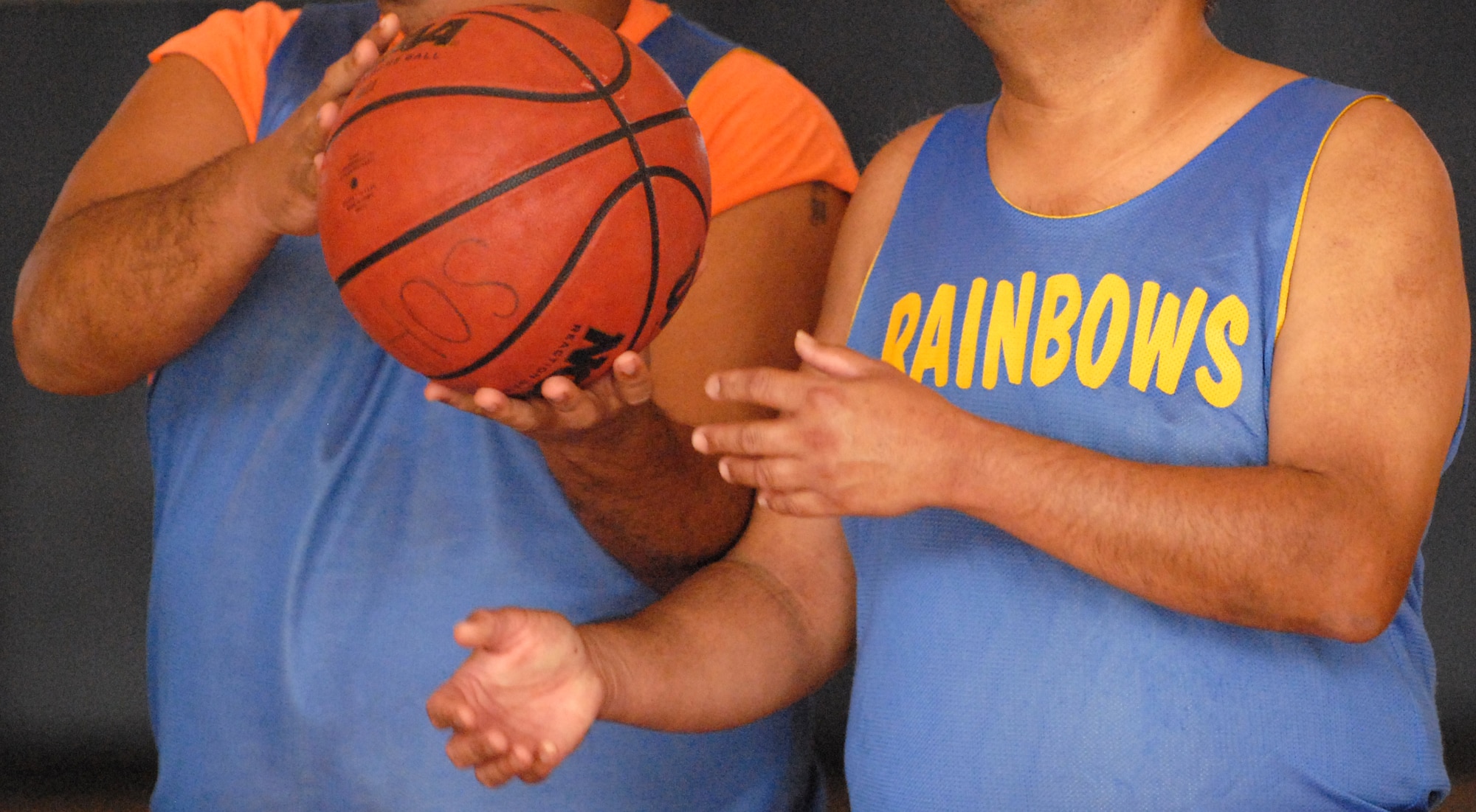 Special Olympics Rainbows basketball team members share a moment of camaraderie during a game at Joint Base Pearl Harbor-Hickam, Hawaii, Dec. 4, 2010. (U.S. Air Force photo/Staff Sgt. Carolyn Viss)