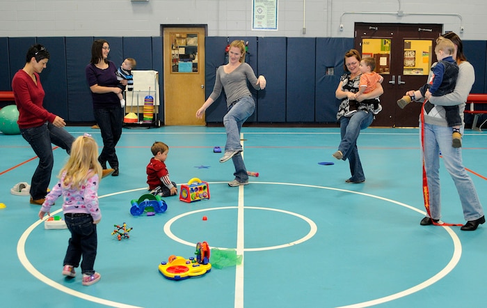 New members of the Joint Base Charleston Military Moms Group sing and dance to the "Hokey Pokey" during a new member welcome orientation Dec. 2, 2010, at the Youth Center on JB CHS-Air Base, S.C. While the children laughed and played, the new members were able to give introductions and talk about their experiences as military spouses or their children. Military Moms is a family oriented group comprised of more than 150 active participants which includes all branches of the military. The next new member orientation is Jan. 6, 2011. The group meets every Thursday at the Youth Center where discussions are held on nutrition, health and fitness, upcoming events and sharing experiences on their children or deployments. For more information, visit the group's website at www.meetup.com/military-moms. (U.S. Navy photo/Mass Communication Specialist 1st Class Jennifer R. Hudson)