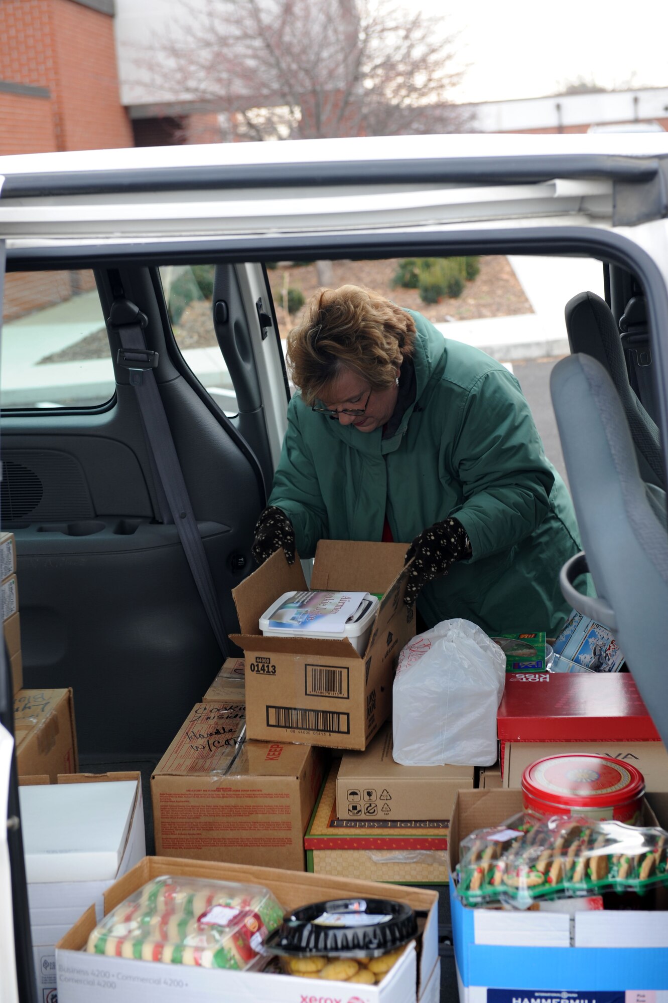 SCOTT AIR FORCE BASE, Ill. – Lynn Blomberg unloads a van of cookies donated from Southwestern Illinois College and Program Services for Older Persons Dec. 7, 2010.  With the help of base volunteers and the local community, the OSC collected over 12,000 cookies to be hand delivered to Airmen in the dorms and around the base. (U.S. Air Force photo/ Airman 1st Class Divine Cox) 