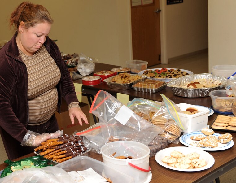 Dawn Schubkegel refills cookies to be bagged and delivered Dec. 7, 2010, to Airmen in the dormitories at Scott Air Force Base, Ill. With the help of base volunteers and the local community, the Scott AFB Officers Spouses Club collected more than 12,000 cookies to be hand delivered to Airmen in the dorms and around the base. (U.S. Air Force Photo/Airman 1st Class Divine Cox) 
