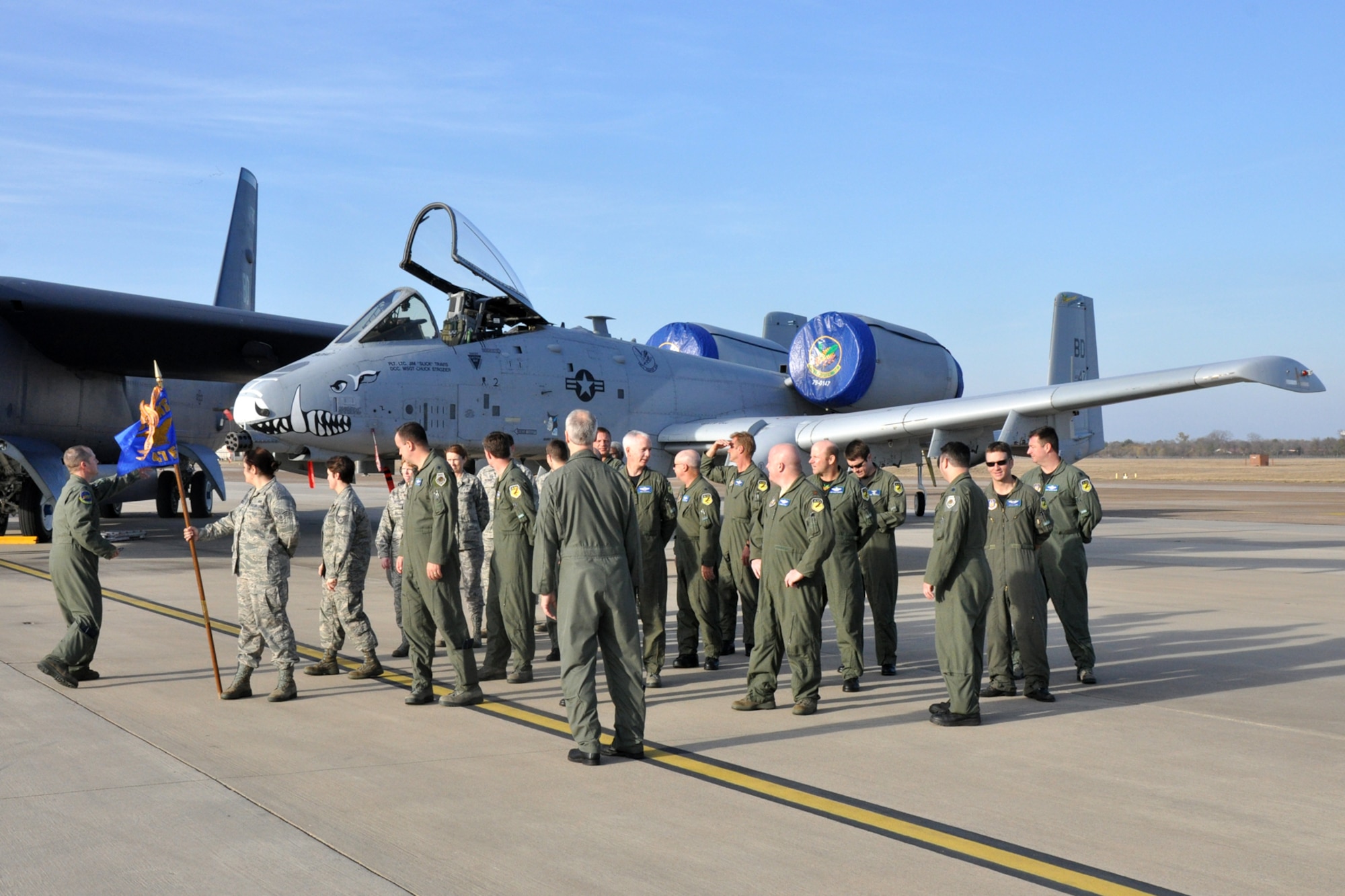 Lt. Col. James Travis, commander, 47th Fighter Squadron, directs personnel to take their places for a group photo during the Unit Training Assembly weekend at Barksdale Air Force Base, La., Dec. 4, 2010. Group, squadron and flight photos were taken for historical purposes during the weekend, since the 917th Wing will soon be deactivated and these will be the last photos taken as the 917th Wing. The wing will be deactivated in ceremonies Jan. 8, 2010 and the 307th Bomb Wing will be reactivated. (U.S. Air Force photo /Tech. Sgt. Jeff Walston)