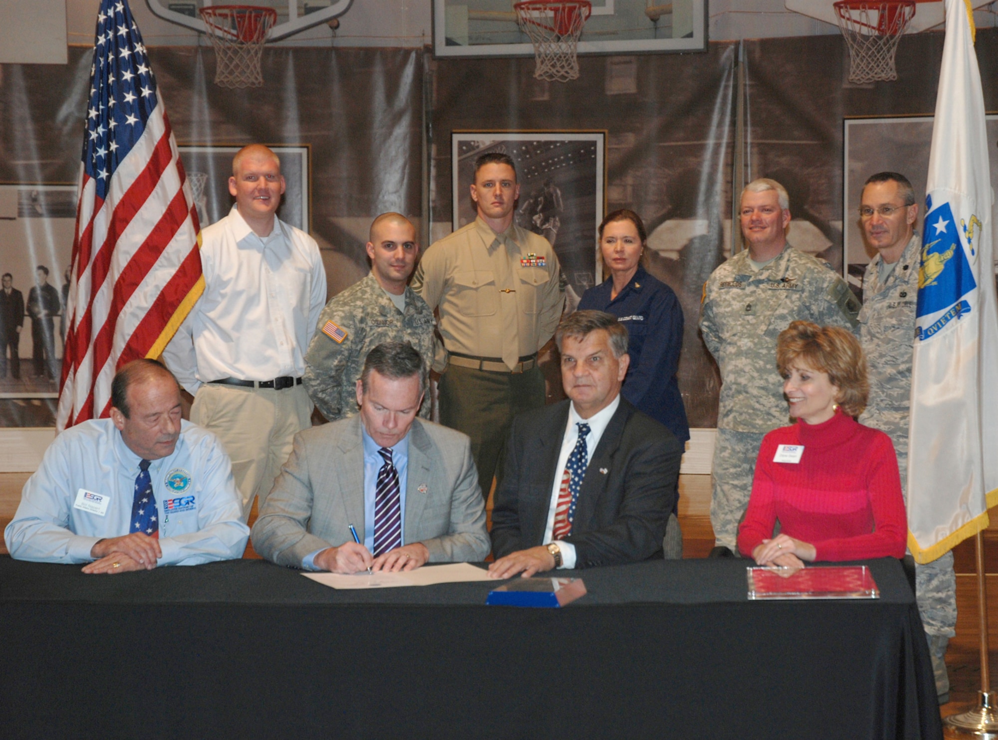 John Doleva, President and CEO of the Basketball Hall of Fame in Springfield, Mass., signs a statement of support for the National Guard and Reserve Dec. 7, surrounded by members from each branch of service and officials from the National Committee for Employer Support of the Guard and Reserve. ESGR, an agency within the Office of the Assistant Secretary of Defense for Reserve Affairs, was established in 1972 to promote cooperation and understanding between Reserve component members and their civilian employers and to assist in the resolution of conflicts arising from an employee's military commitment. Employers may sign a statement of support, and reservists may recognize their employers with a "My Boss is a Patriot" award to show appreciation for support and cooperation with an employee's reserve status.  More information is available at www.esgr.org.
