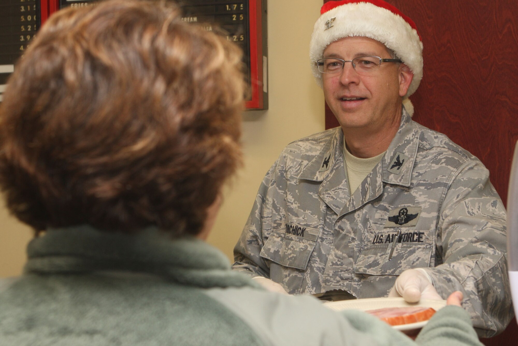 Col. Timothy E. Tarchick, 94th Airlift Wing Commander heads up the serving line during lunch at the Dec. 4 unit training assembly. (U.S. Air Force Photo/Don Peek)


