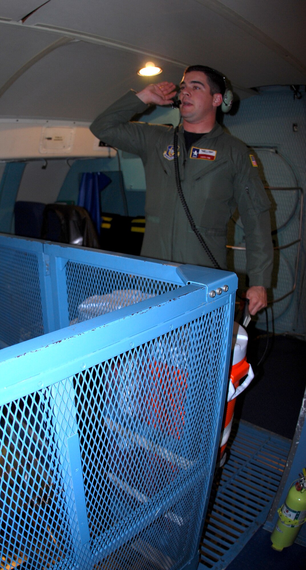 Staff Sgt. David Fink, a C-5 Galaxy loadmaster with the 68th Airlift Squadron, gives preflight instructions to guests attending the 433rd Airlift Wing's 17th Annual Bosses Day, Dec. 4, 2010, at Lackland Air Force Base, Texas. Thirty-six civilian employers of Alamo wing reservists witnessed a mid-air refueling by a KC-135 during the flight. The annual event is designed to help civilian employers understand the importance of the mission thier workers carry out while serving on Reserve status. (U.S. Air Force photo/Senior Airman Luis Loza Gutierrez)