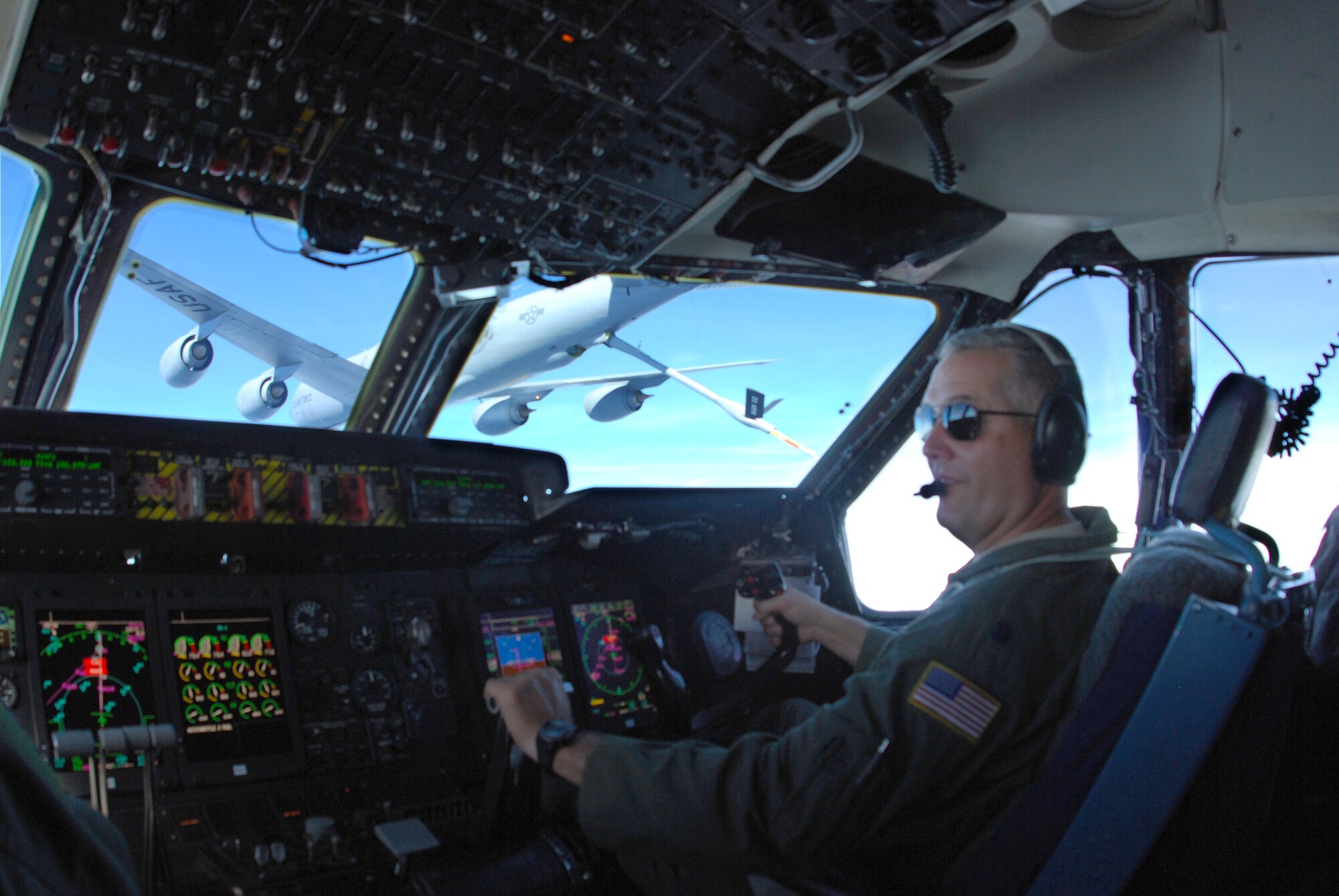 Lt. Col. Pat Brooks, a C-5 Galaxy pilot with the 68th Airlift Squadron, carefully manuevers the C-5 Galaxy cargo into position for a mid air refueling with a KC-135 Stratotanker as part of the 433rd Airlift Wing's 17th Annual Bosses Day, Dec. 4, 2010, at Lackland Air Force Base, Texas. Thirty-six civilian employers of Alamo wing reservists witnessed the mid-air refueling and learned about the various missions performed by the wing. The annual event is designed to help civilian employers understand the importance of the mission thier workers carry out while serving on Reserve status. (U.S. Air Force photo/Senior Airman Luis Loza Gutierrez)