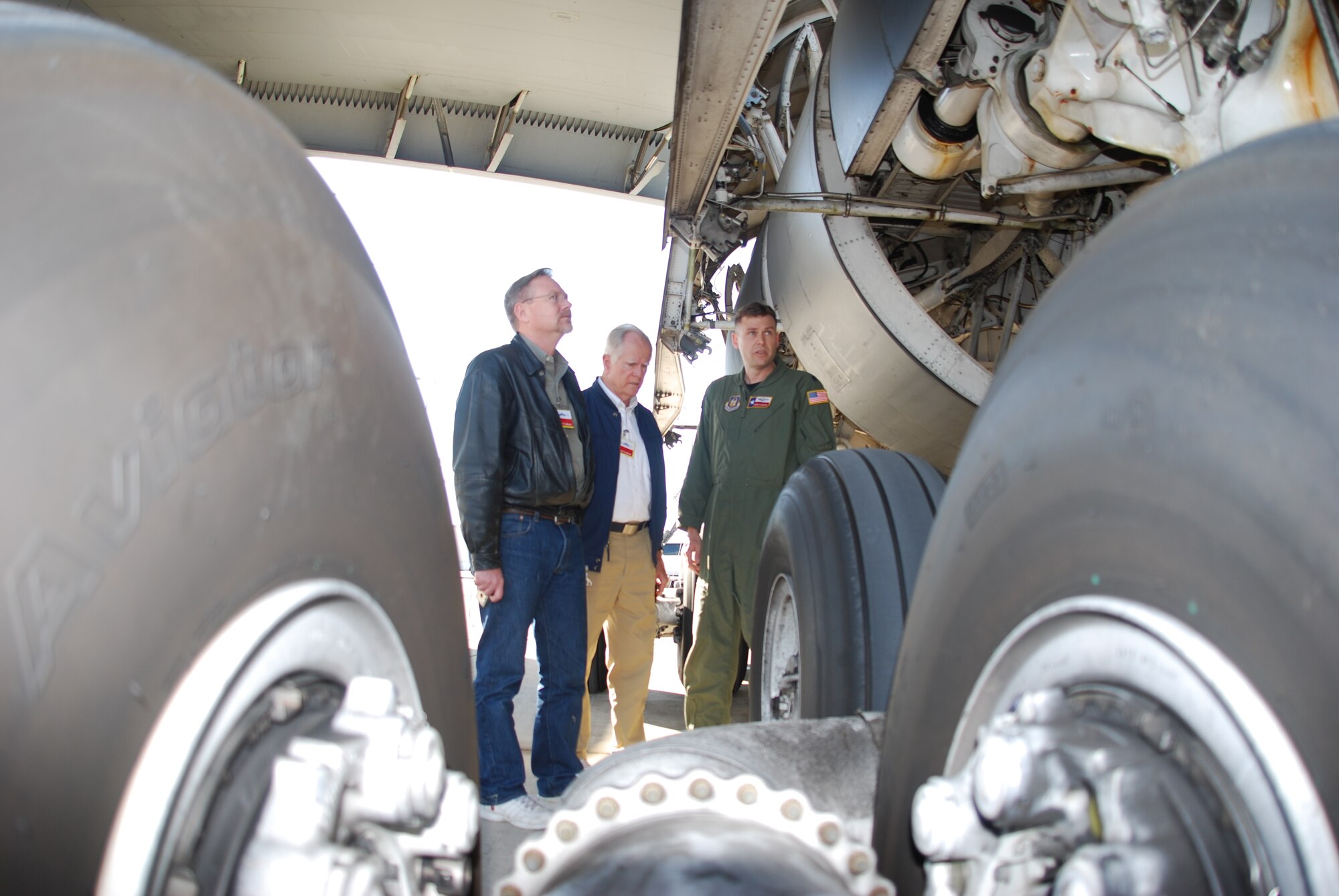 Lt. Col. Shane Slaughter, a C-5 Galaxy pilot with the 68th Airlift Squadron, takes a few minutes to talk about the C-5 to two guests attending the 433rd Airlift Wing's 17th Annual Bosses Day, Dec. 4, 2010, at Lackland Air Force Base, Texas. Thirty-six bosses witnessed a mid-air refueling between this C-5 and a KC-135 Stratotanker. (U.S. Air Force photo/Senior Airman Luis Loza Gutierrez)