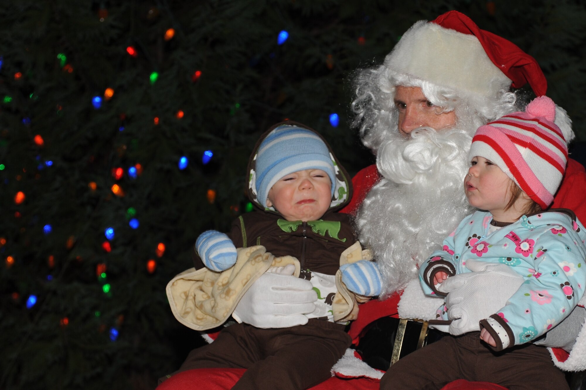 SEYMOUR JOHNSON AIR FORCE BASE, N.C. – Brennan and Alexis Thomas sit on Santa Claus’ lap during a Christmas tree lighting ceremony in the Base Exchange parking lot Dec. 6, 2010. Santa Claus arrived at the ceremony in a horse-drawn sleigh minutes after the base tree was lit. Brennan and Alexis are the children of Staff Sgt. Shawn Thomas, who is assigned to the 911th Air Refueling Squadron.  (U.S. Air Force photo/Tech. Sgt. Tammie Moore)