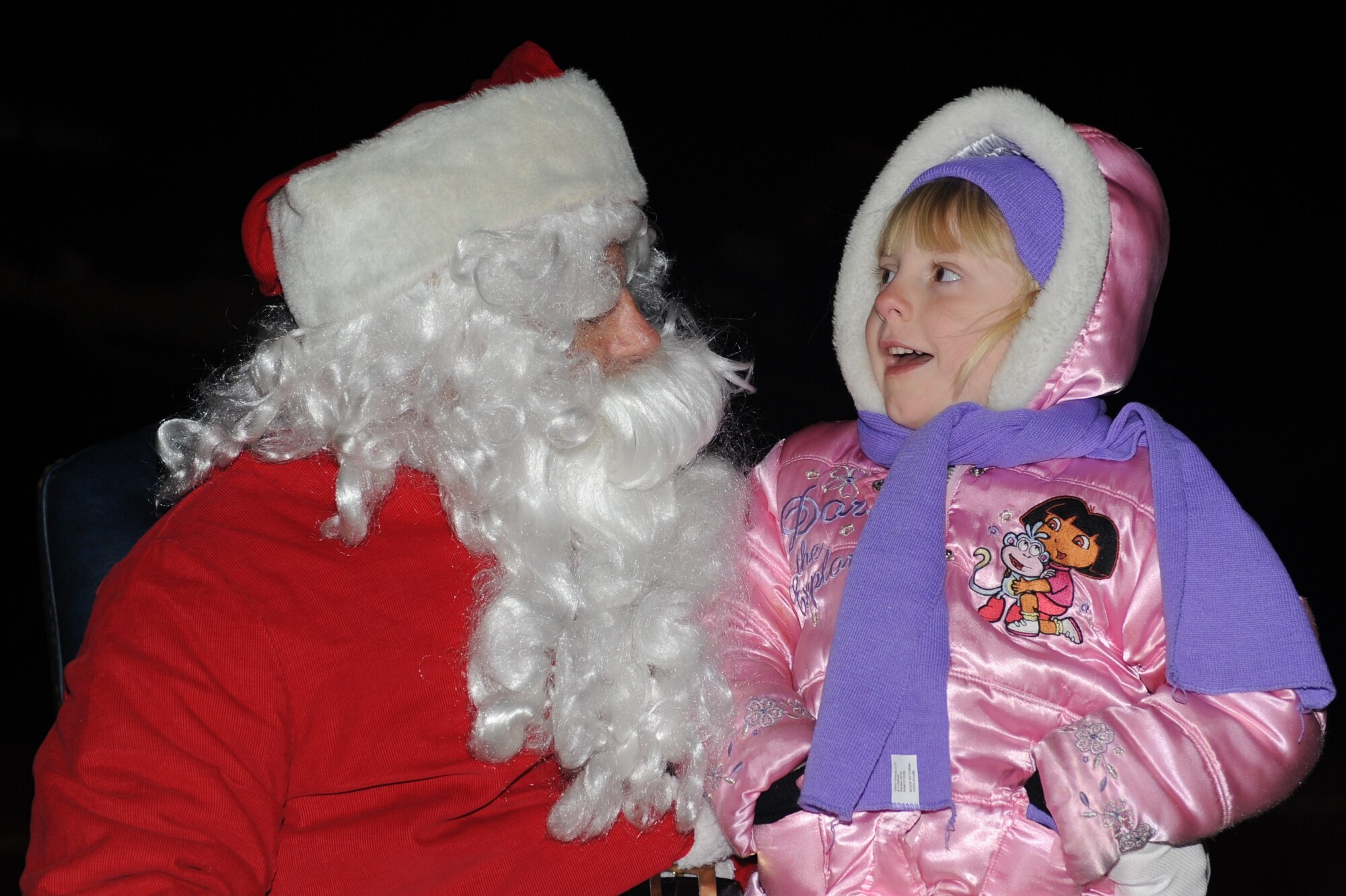 SEYMOUR JOHNSON AIR FORCE BASE, N.C. – Ashley Moore tells Santa Claus she wants an iPod for Christmas during the base Christmas tree lighting ceremony in the Base Exchange parking lot Dec. 6, 2010. Santa Claus traveled here to participate in the evening’s events, which included children’s renditions of Christmas carols, a performance by the Singing Stripes and a martial arts demonstration. Ashley is the granddaughter of retired Tech. Sgt. Danny Boren.  (U.S. Air Force photo/Tech. Sgt. Tammie Moore)