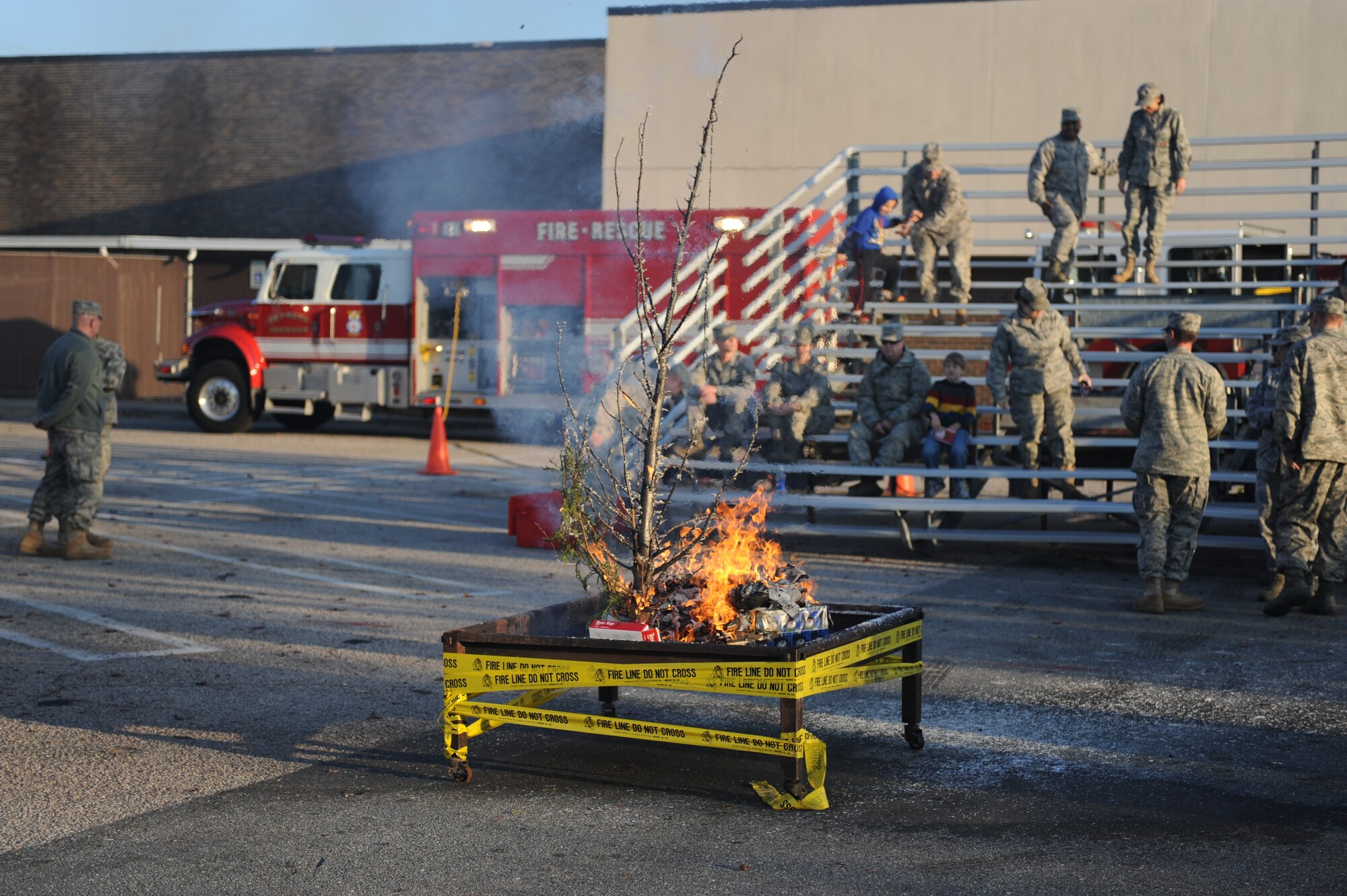 The remnants of a Christmas tree smolder during a demonstration on the dangers of failing to keep a fresh Christmas tree watered Dec. 3, 2010, at the Base Exchange. The 4th Civil Engineer Squadron’s Fire Services Flight held an informational demonstration highlighting Christmas tree safety to remind members of the Seymour Johnson community about the possible dangers associated with Christmas trees. Every year, fire departments around America respond to more than 200 structure fires started by Christmas decorations. (U.S. Air Force photo/ Senior Airman Marissa Tucker)