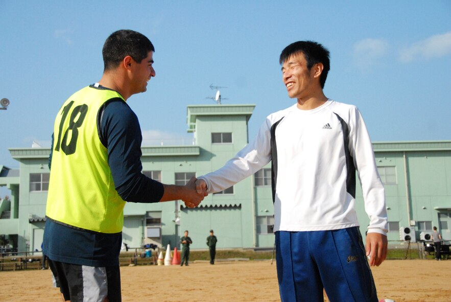 Two team captains shake hands prior to a soccer scrimmage with players from the U.S. Air Force and Japan Self-Defense Force at Komatsu, Japan, Dec. 5, 2010. The grouped played soccer during down time in Keen Sword operations. (U.S. Air Force photo by 1st Lt. Cammie Quinn/Released)